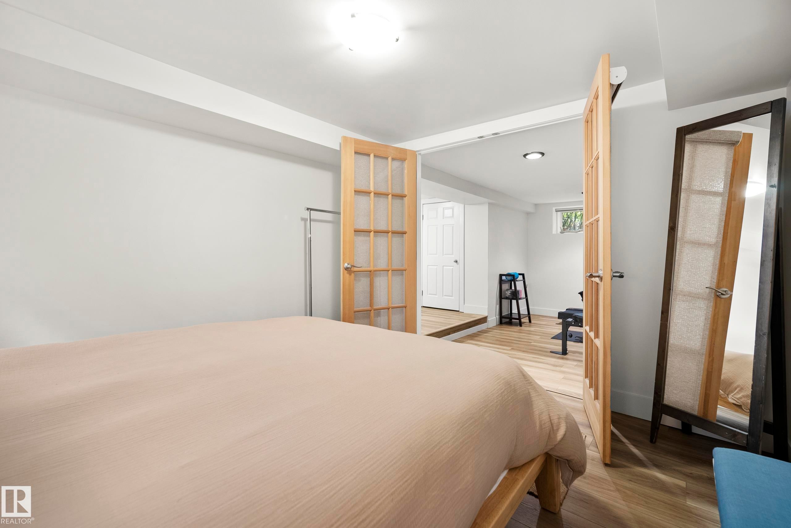 White walls with recessed lighting and wood-finish flooring - 11006 64 Avenue Nw, Edmonton, AB