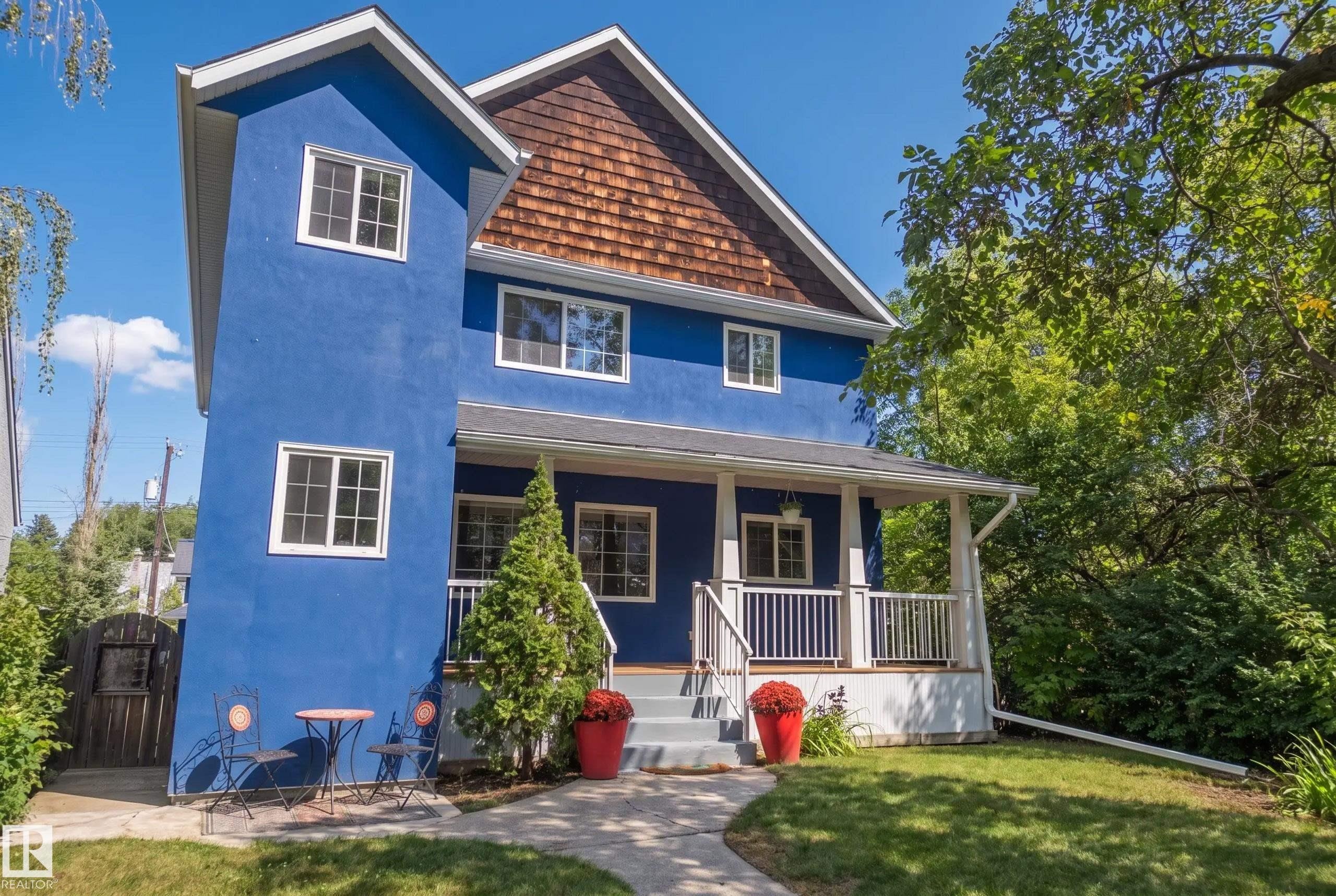 Blue stucco exterior with white trim windows - 11006 64 Avenue Nw, Edmonton, AB