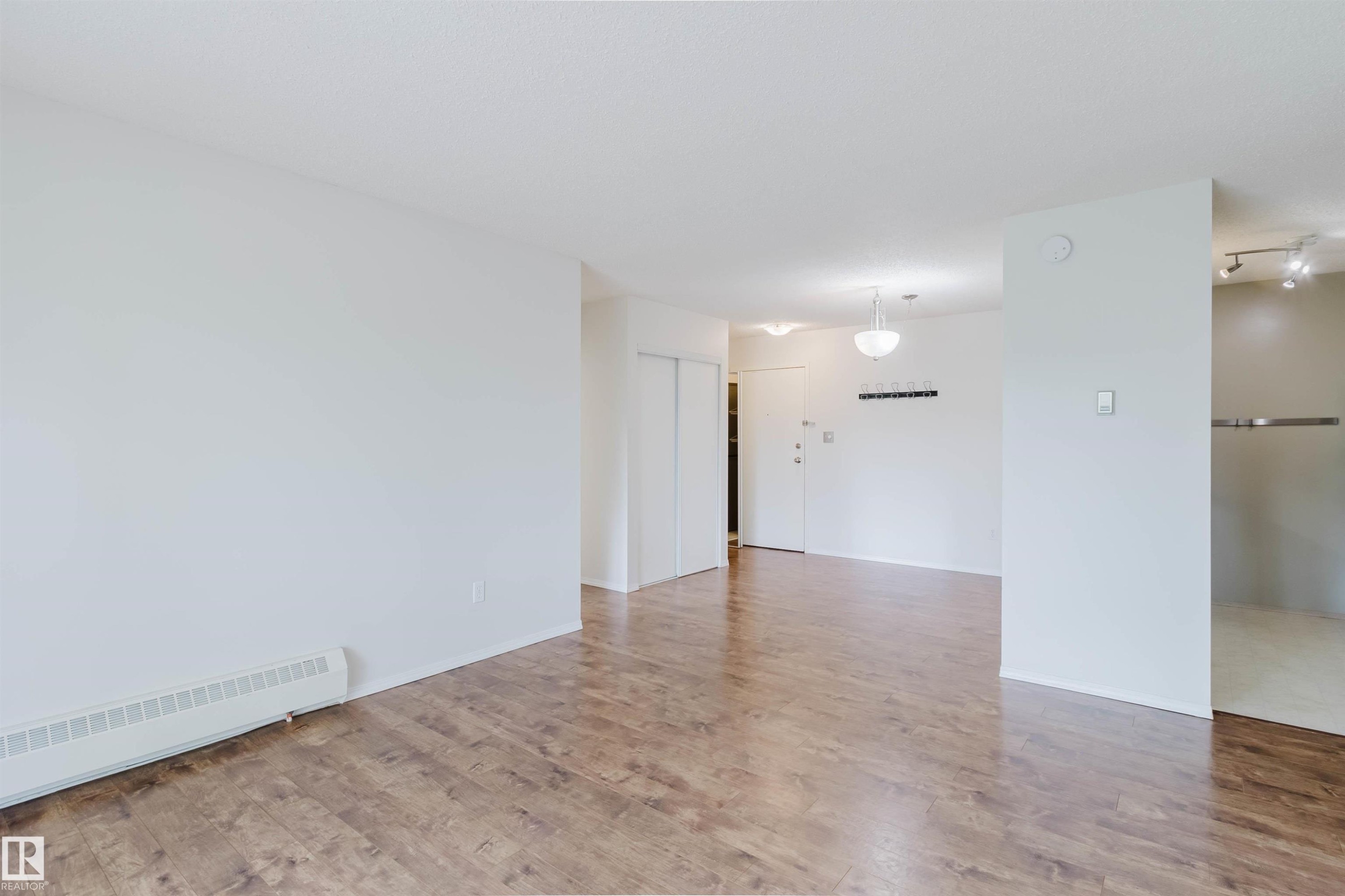 Wood-finish flooring throughout, white painted walls, and ceiling-mounted light fixtures - #316 17109 67 Av Nw, Edmonton, AB