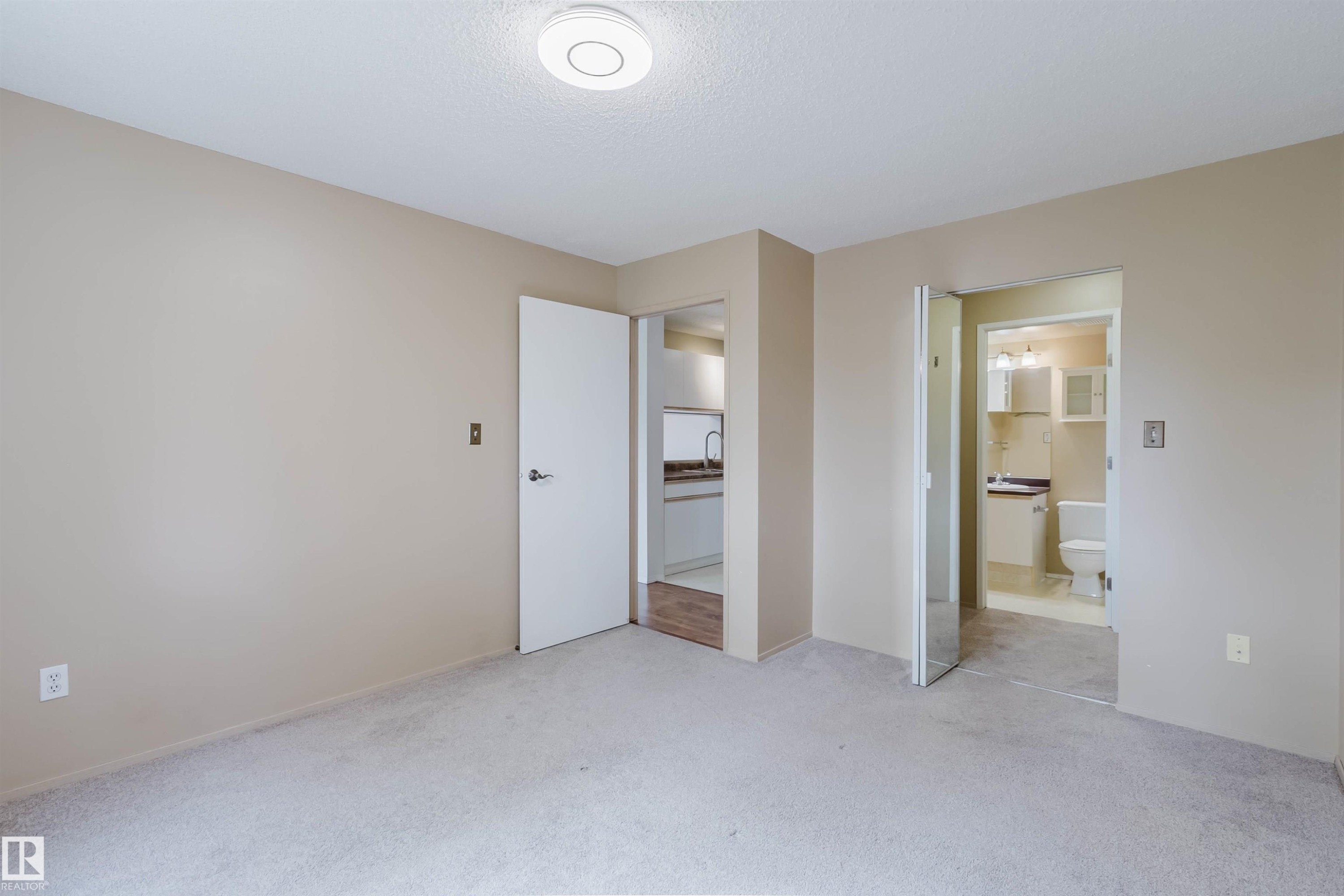 Neutral-toned walls complement the light-colored carpeting - #316 17109 67 Av Nw, Edmonton, AB