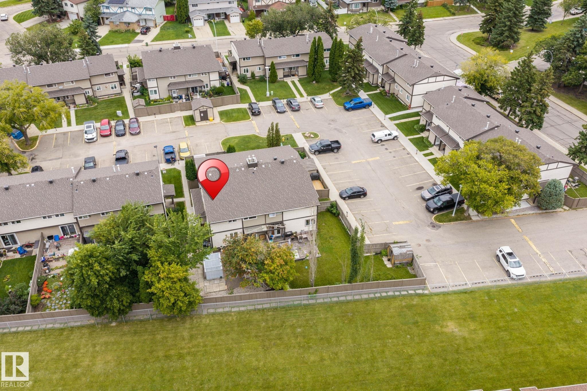 Townhouse unit with an attached private patio and a fenced backyard area - 716 Clareview Rd Nw, Edmonton, AB