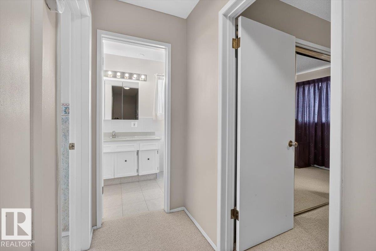 Hallway featuring light-toned carpet flooring - 4027 74 Street Nw, Edmonton, AB - Indoor Photo Showing Other Room