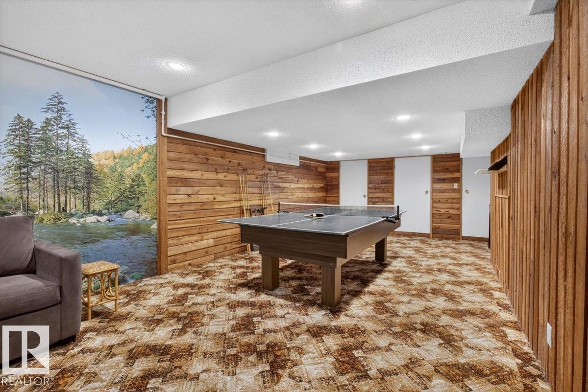 Recreation room featuring wood paneling, recessed lighting, and a patterned carpet - 4027 74 Street Nw, Edmonton, AB - Indoor Photo Showing Other Room