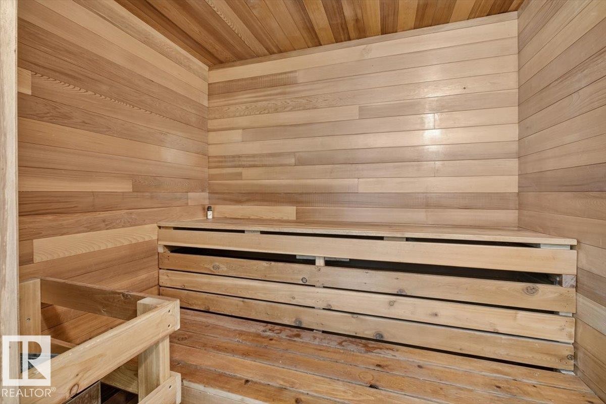 Private sauna featuring wood-paneled walls and ceiling, multi-tiered wood bench seating, and wood-plank flooring - 4027 74 Street Nw, Edmonton, AB - Indoor Photo Showing Other Room