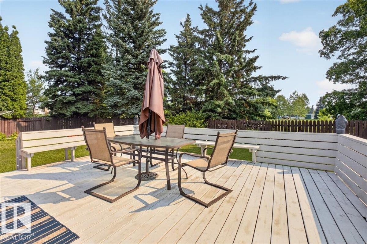 Expansive outdoor deck featuring light-colored decking, integrated bench seating, and privacy fencing - 4027 74 Street Nw, Edmonton, AB - Outdoor With Deck Patio Veranda