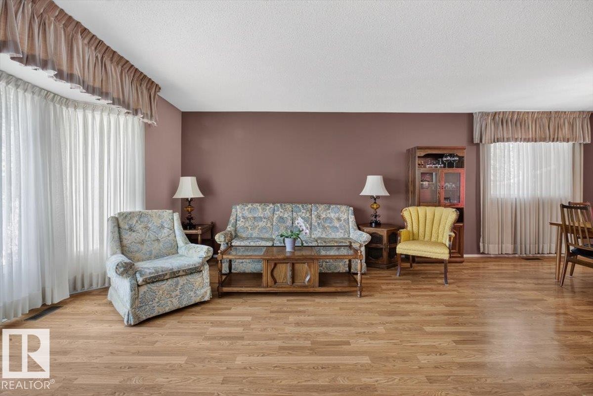 Expansive living area featuring wood-finish flooring - 4027 74 Street Nw, Edmonton, AB - Indoor Photo Showing Living Room