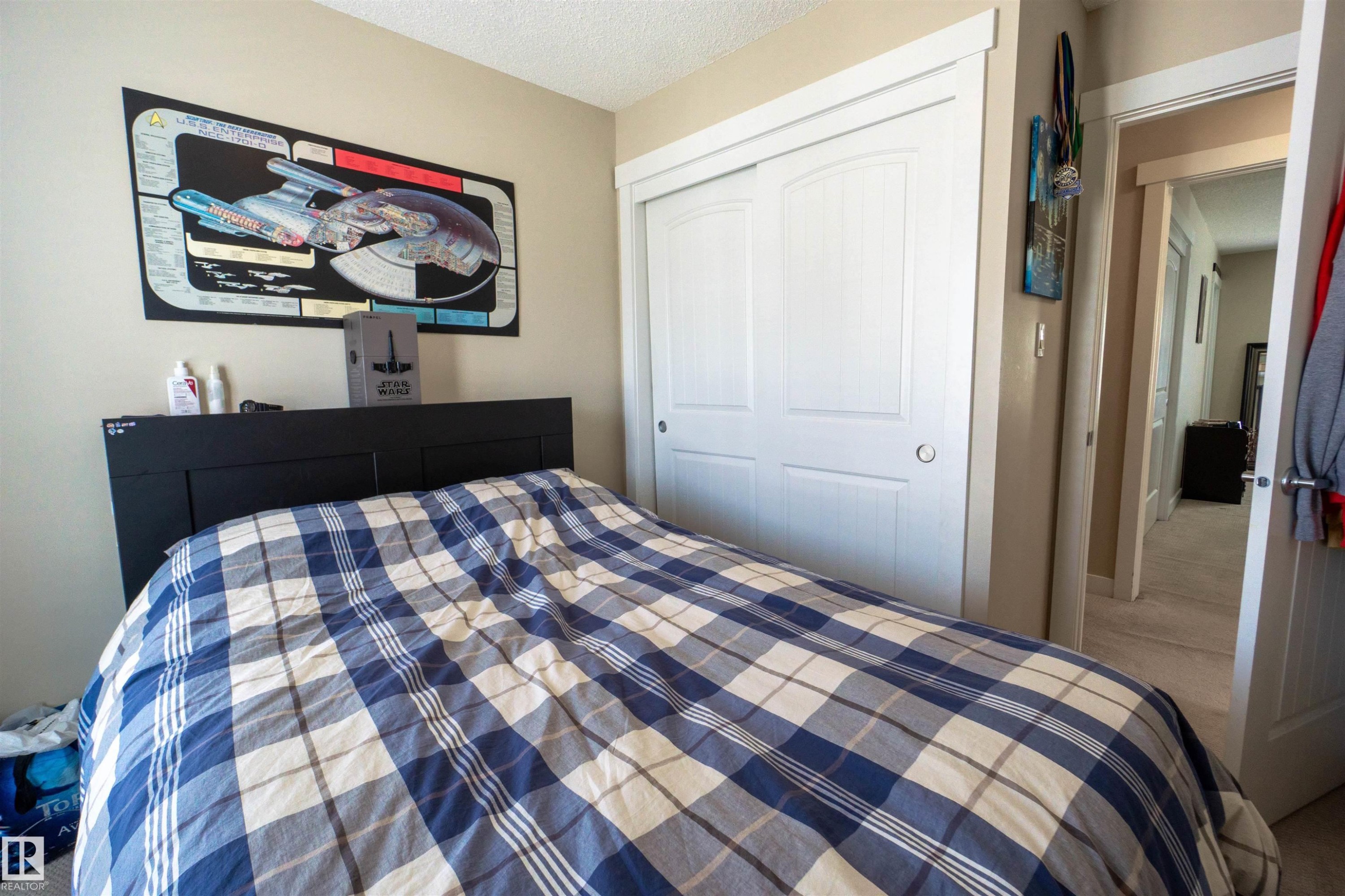White bi-fold closet doors with brushed nickel hardware - #75 8315 180 Av Nw, Edmonton, AB