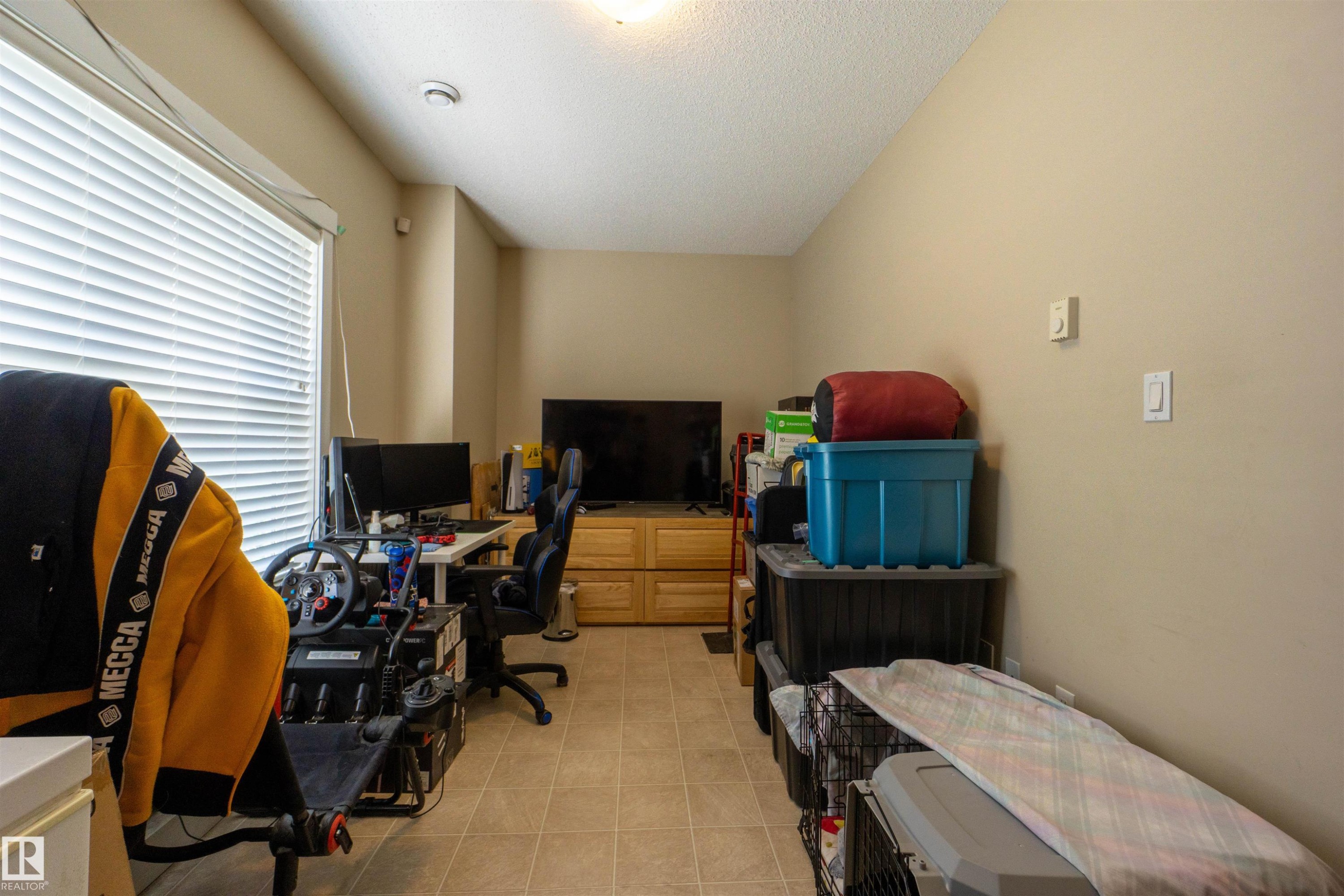 Room featuring light-toned wall paint and a textured ceiling - #75 8315 180 Av Nw, Edmonton, AB