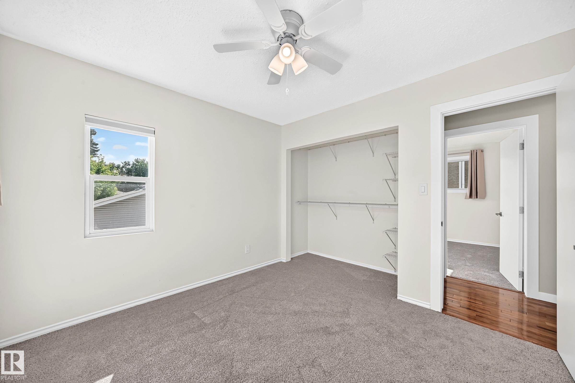 Recessed window, ceiling fan, open closet with wire shelving, and carpet flooring - 12721 117 Street Nw, Edmonton, AB
