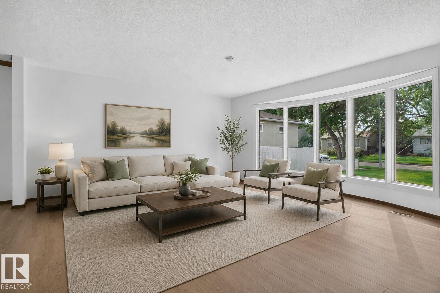 Bright living area featuring wood-finish flooring and a large bay window - 12121 42 Street Nw, Edmonton, AB - Indoor Photo Showing Living Room