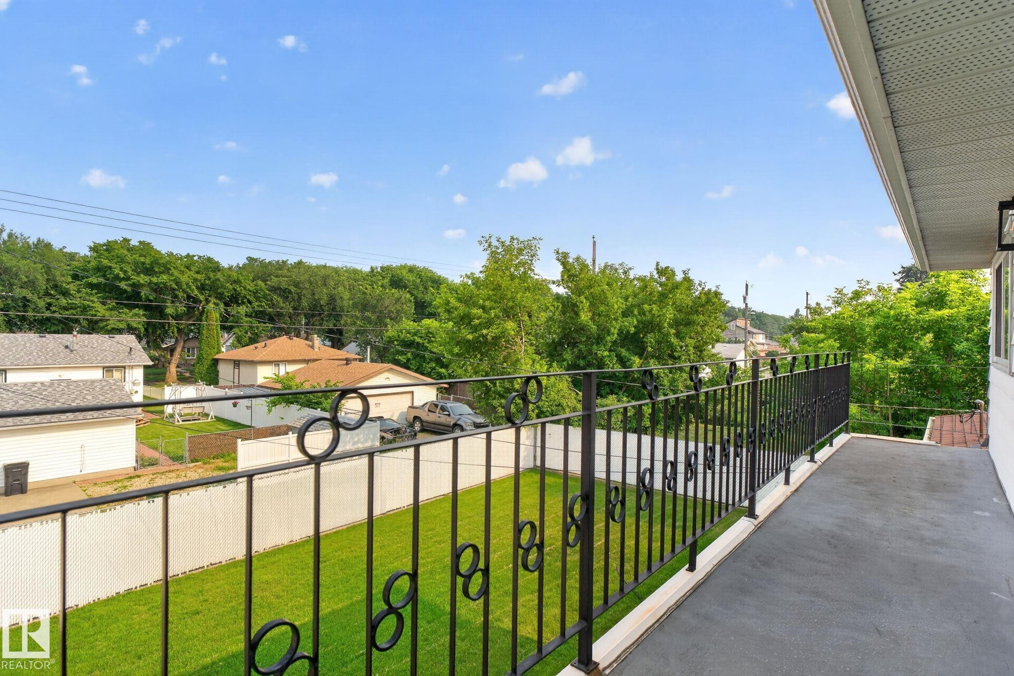 Exterior balcony featuring a painted concrete surface and decorative wrought iron railing - 12121 42 Street Nw, Edmonton, AB - Outdoor