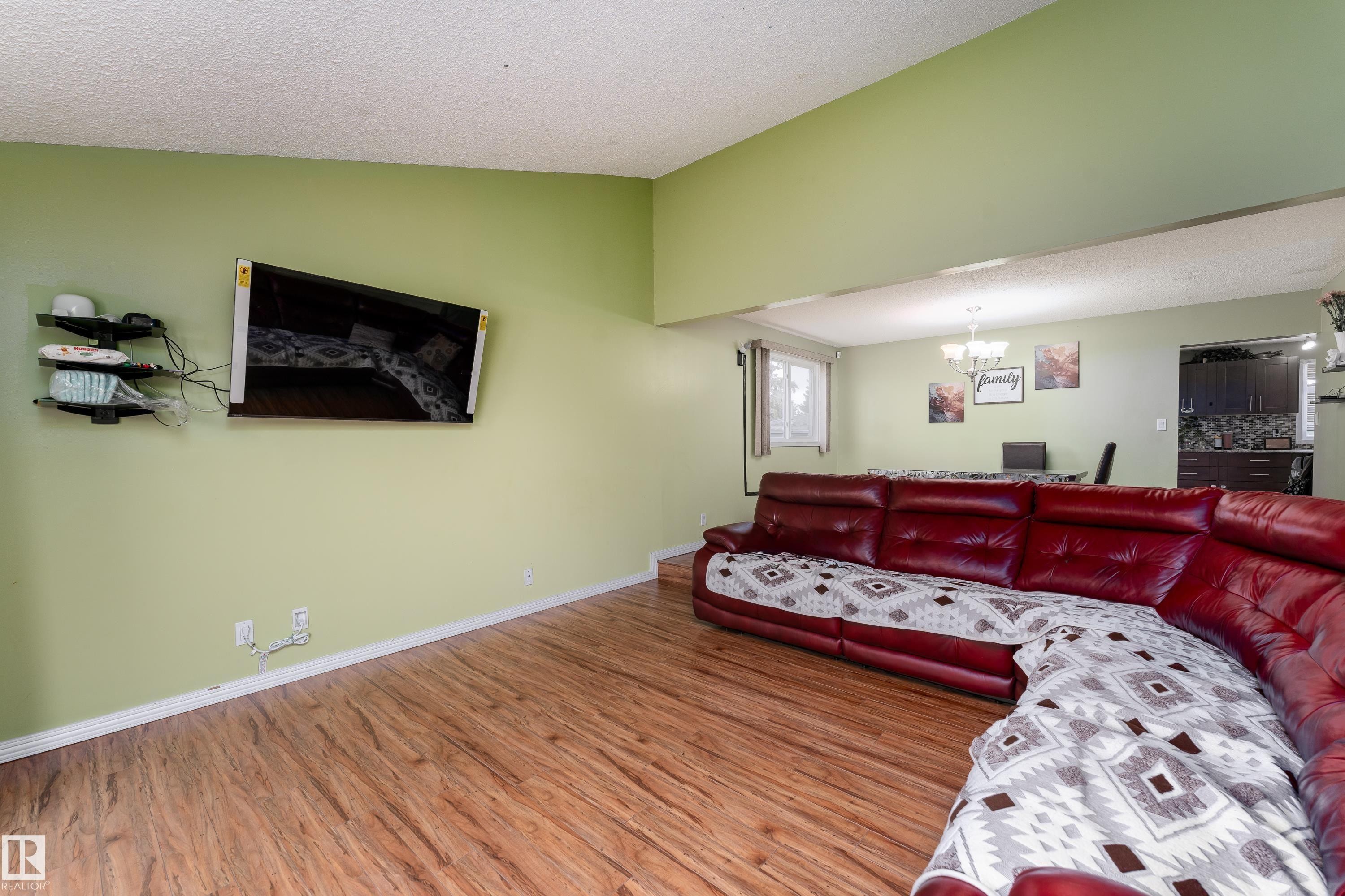 Wood-finish flooring throughout, with a recessed ceiling detail - 17928 93 Ave Nw, Edmonton, AB