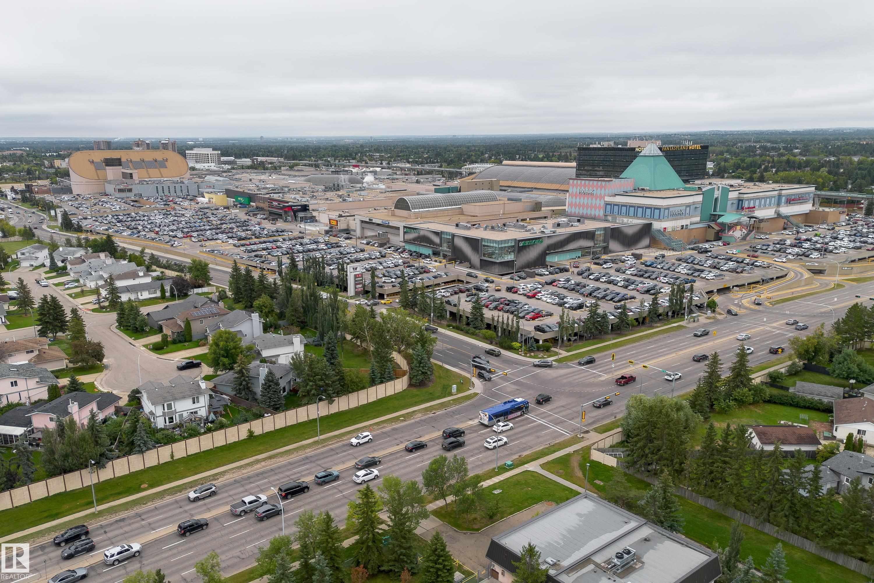Aerial perspective showcasing a major commercial complex with extensive parking areas, multiple large-scale buildings, and surrounding residential properties - 17928 93 Ave Nw, Edmonton, AB