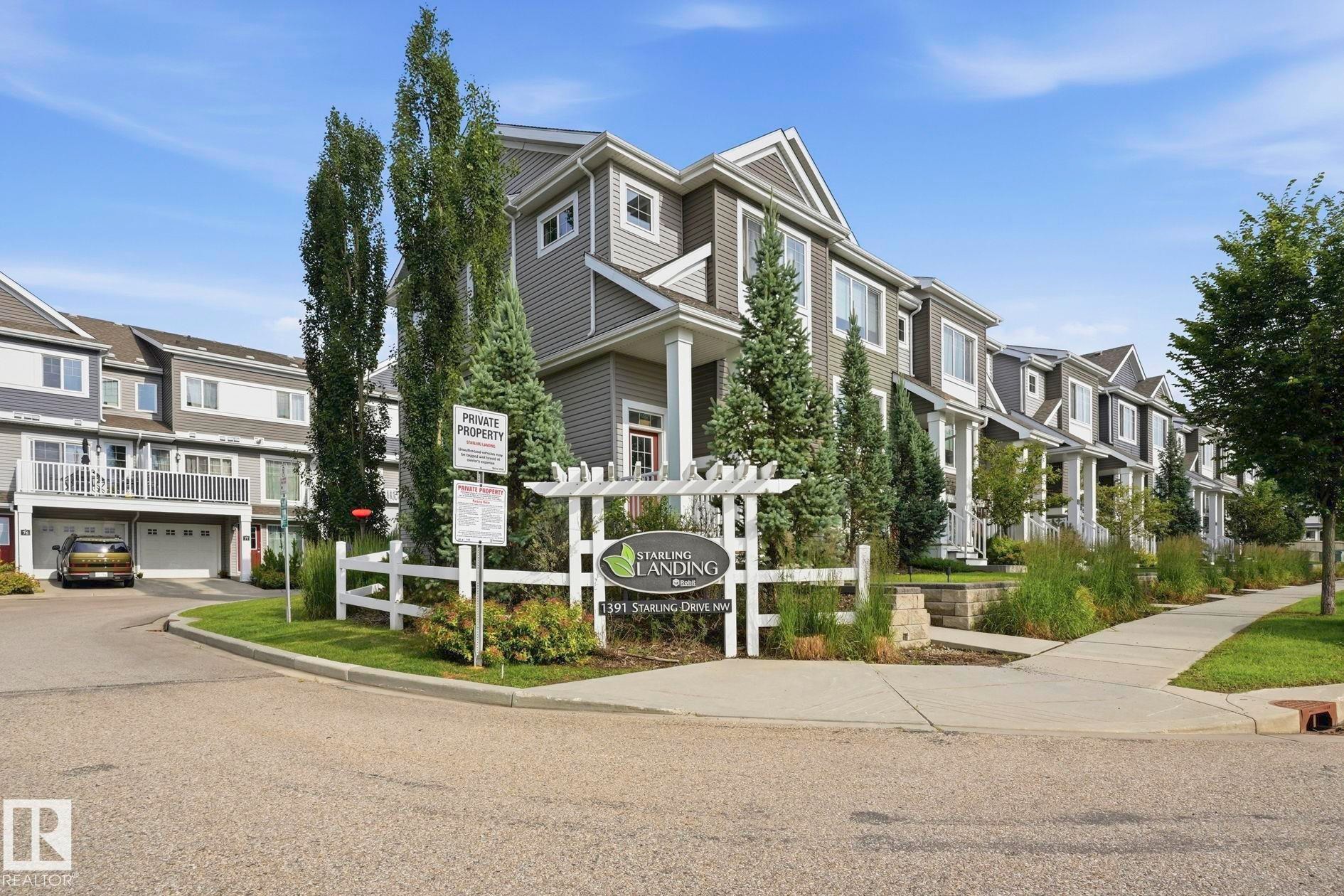 Townhome exteriors feature siding and gabled rooflines - #12 1391 Starling Dr Nw, Edmonton, AB