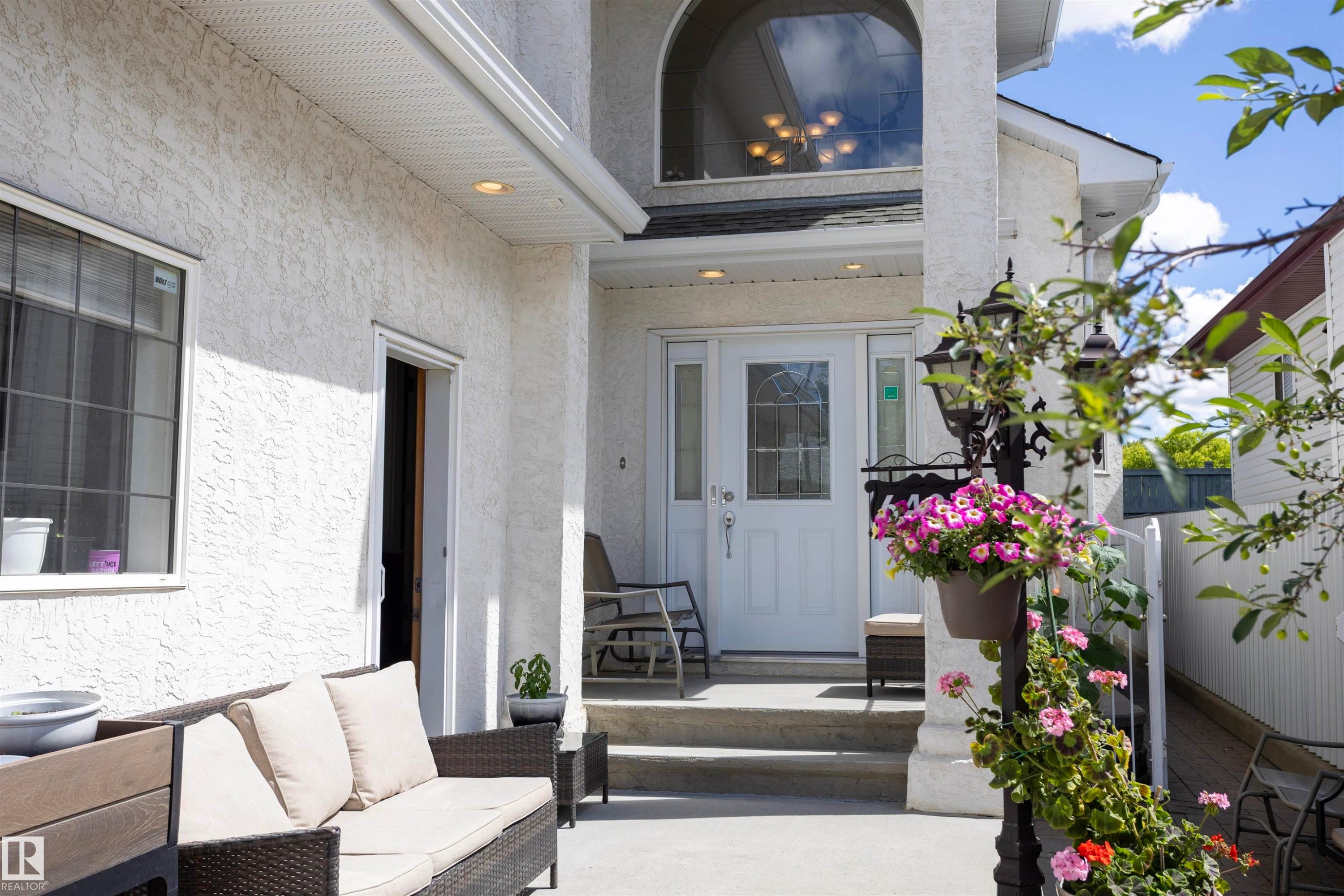 Inviting entryway featuring a white glass-paneled door, arched window, and recessed lighting - 6407 163 Avenue Nw, Edmonton, AB
