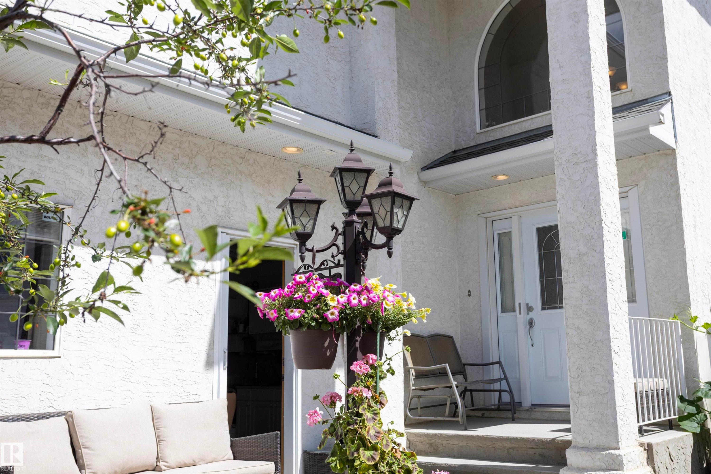 Stucco exterior featuring dual entry doors with decorative glass panels - 6407 163 Avenue Nw, Edmonton, AB
