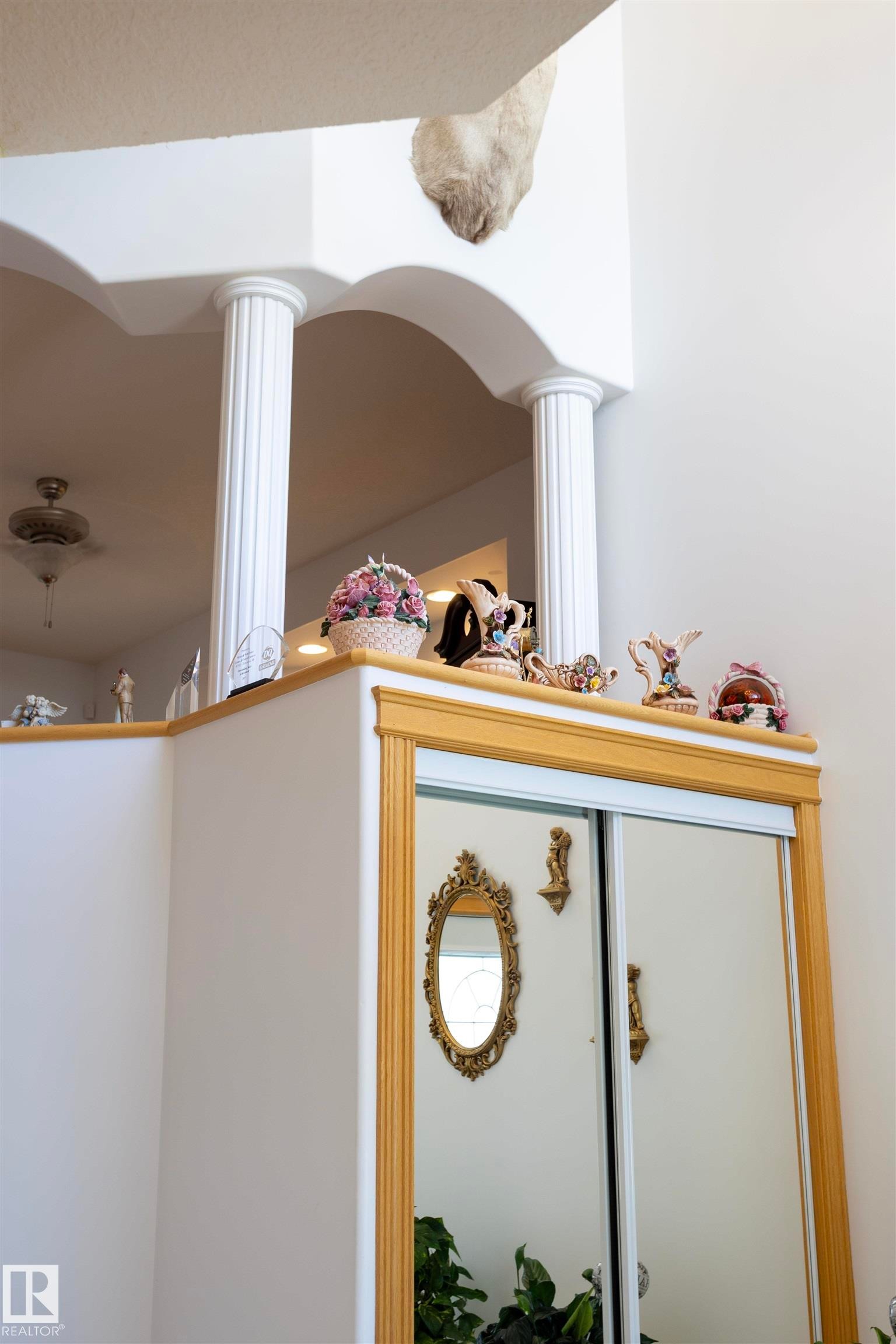 Archway with decorative fluted columns and upper-level railing - 6407 163 Avenue Nw, Edmonton, AB
