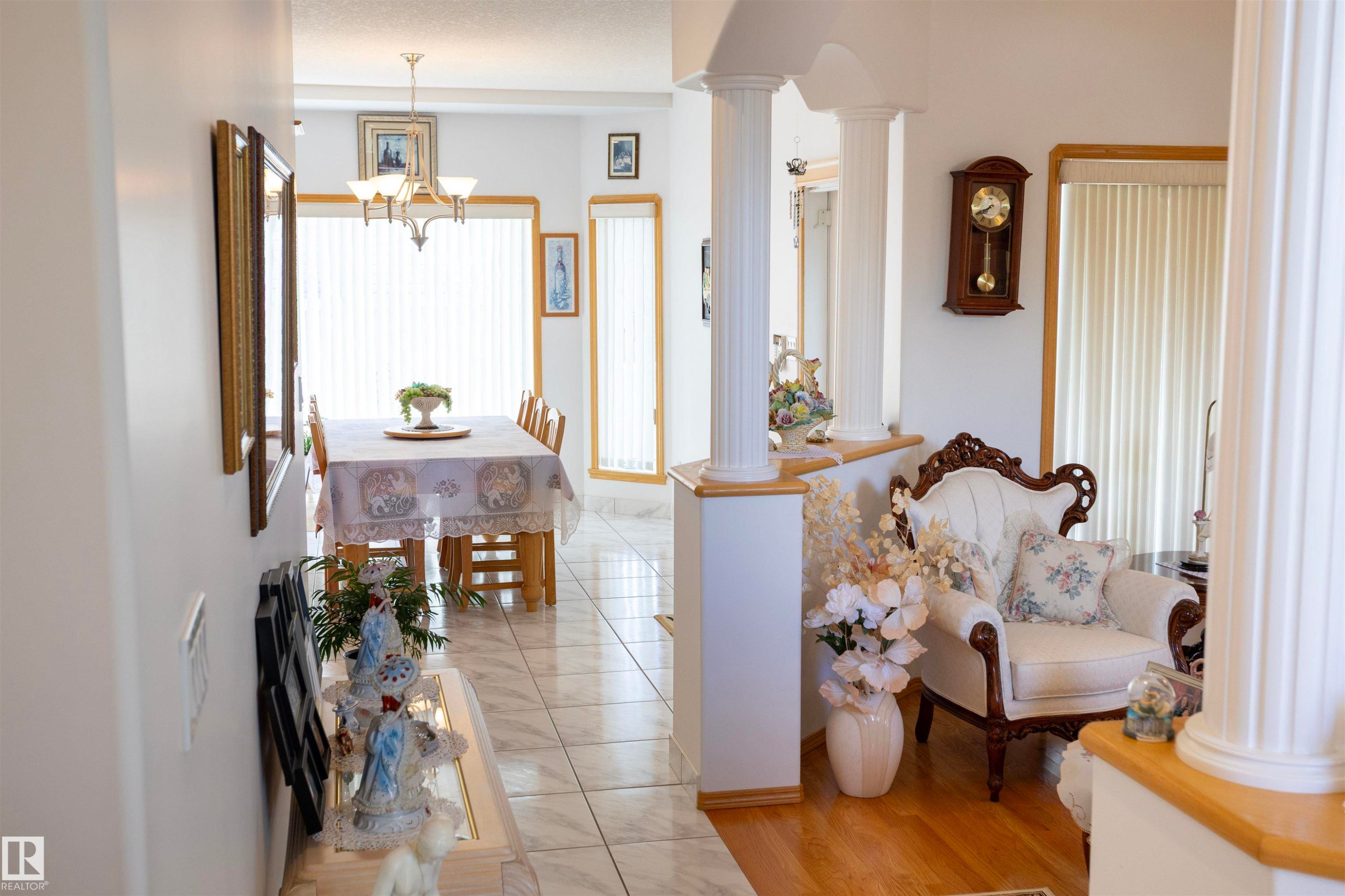 Hallway featuring decorative columns and a half-wall partition - 6407 163 Avenue Nw, Edmonton, AB