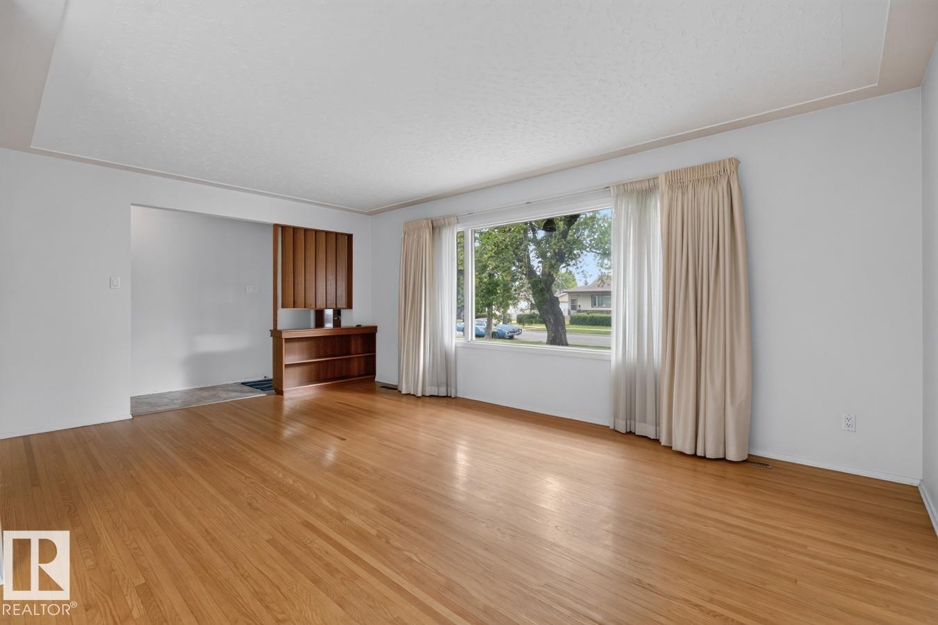Hardwood flooring, expansive window, built-in shelving, architectural wall divider - 12424 77 Street Nw, Edmonton, AB
