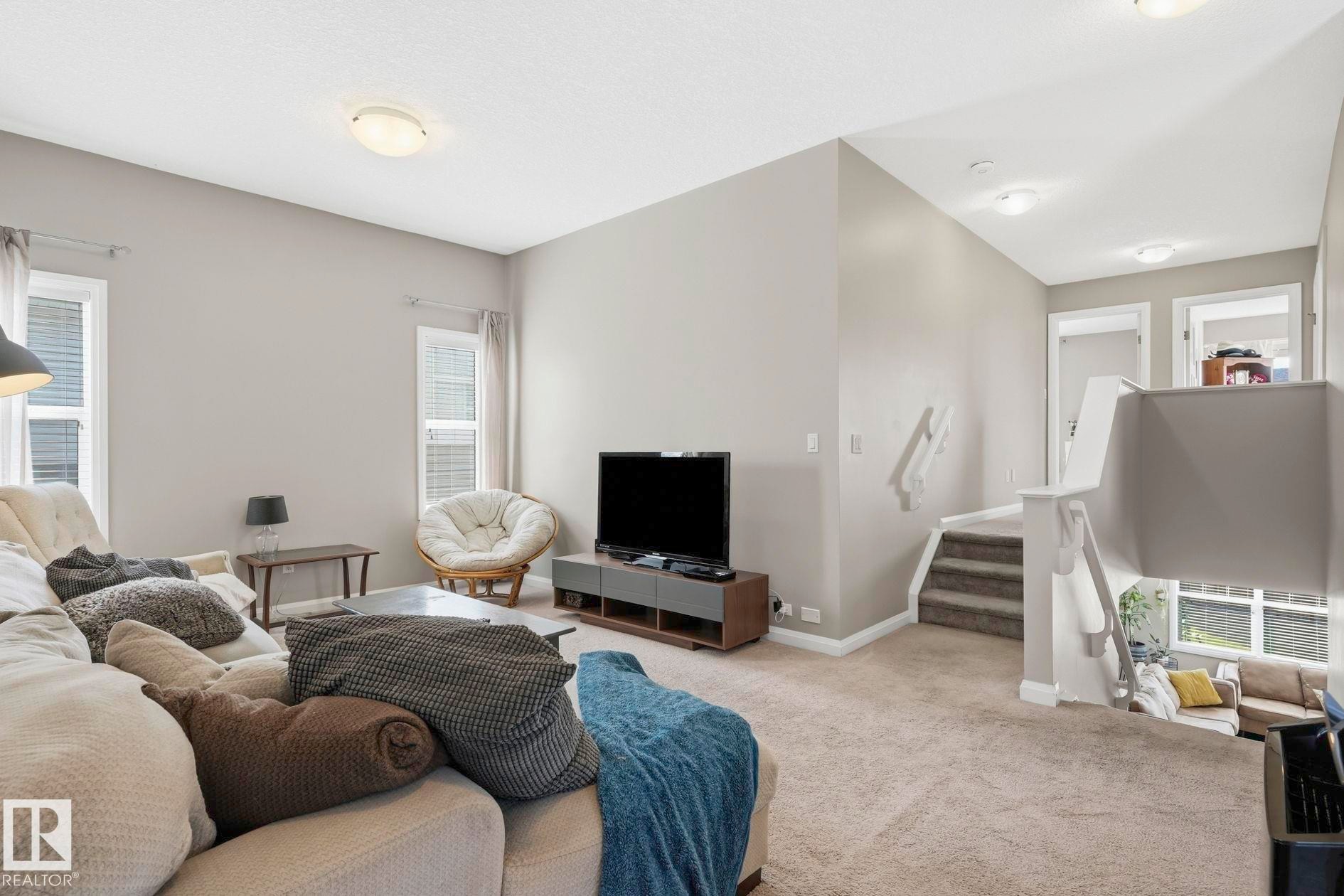 Living area featuring neutral wall tones, carpeted flooring, and recessed lighting - 3204 Abbott Crescent Sw, Edmonton, AB - Indoor Photo Showing Living Room
