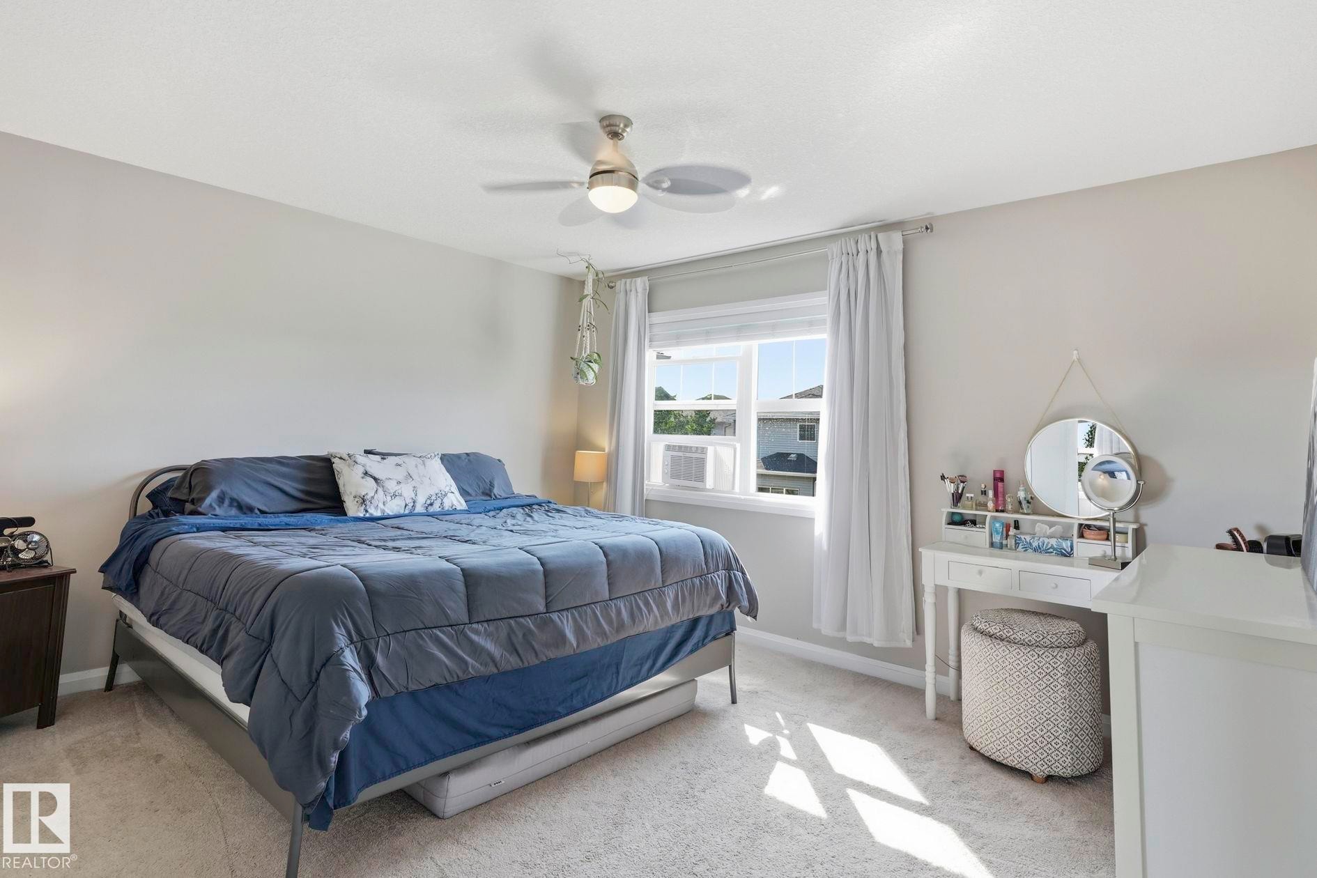 Carpeted bedroom featuring light gray walls and a single window with white trim - 3204 Abbott Crescent Sw, Edmonton, AB - Indoor Photo Showing Bedroom