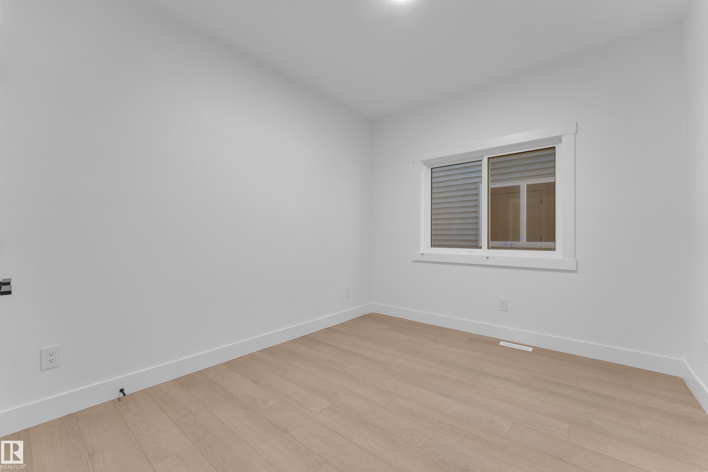Wood-finish flooring, white walls, and a window with white trim - 226 Linden Loop, Leduc, AB