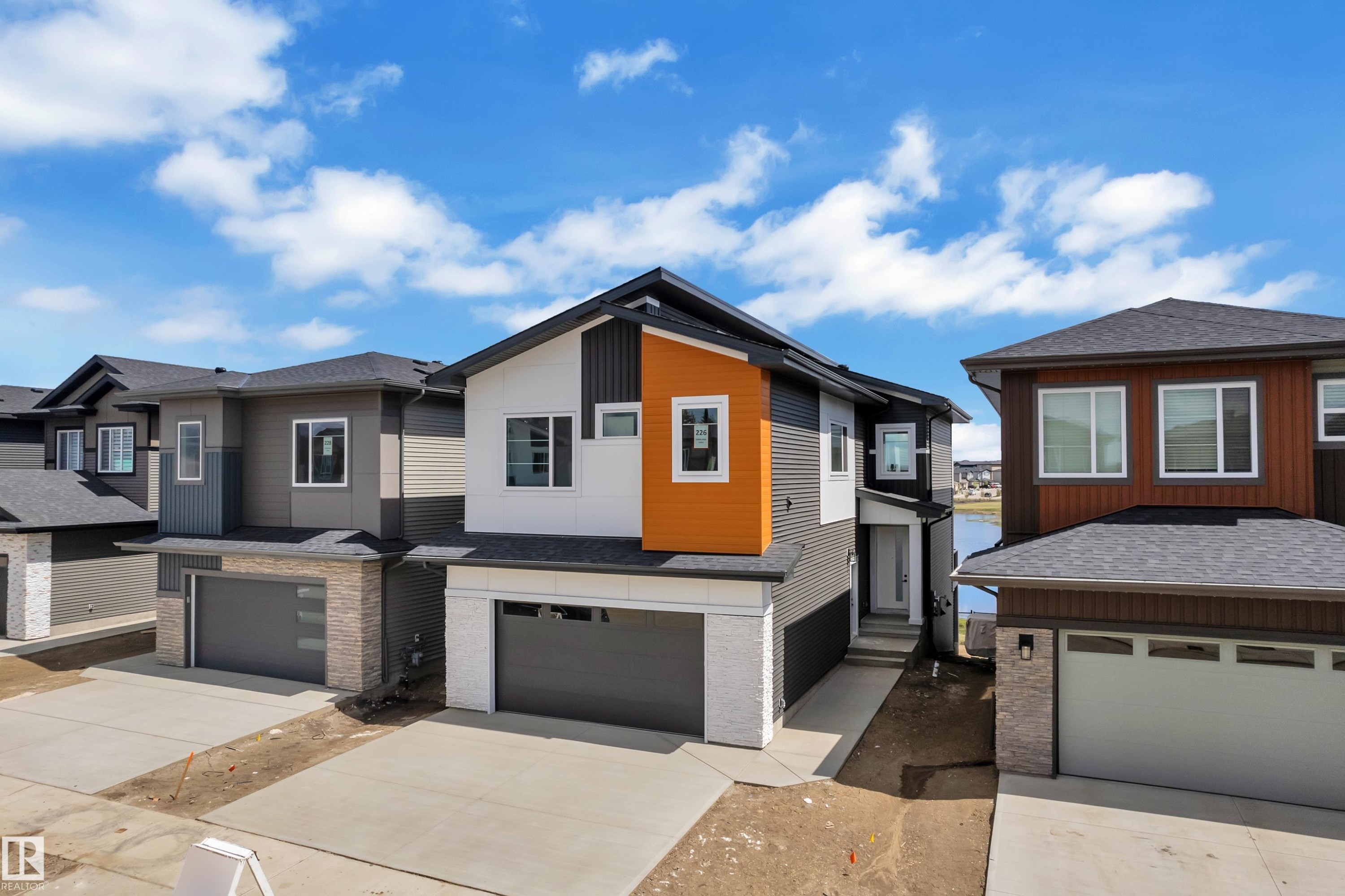 Contemporary exterior with contrasting siding, attached garage, and concrete driveway - 226 Linden Loop, Leduc, AB