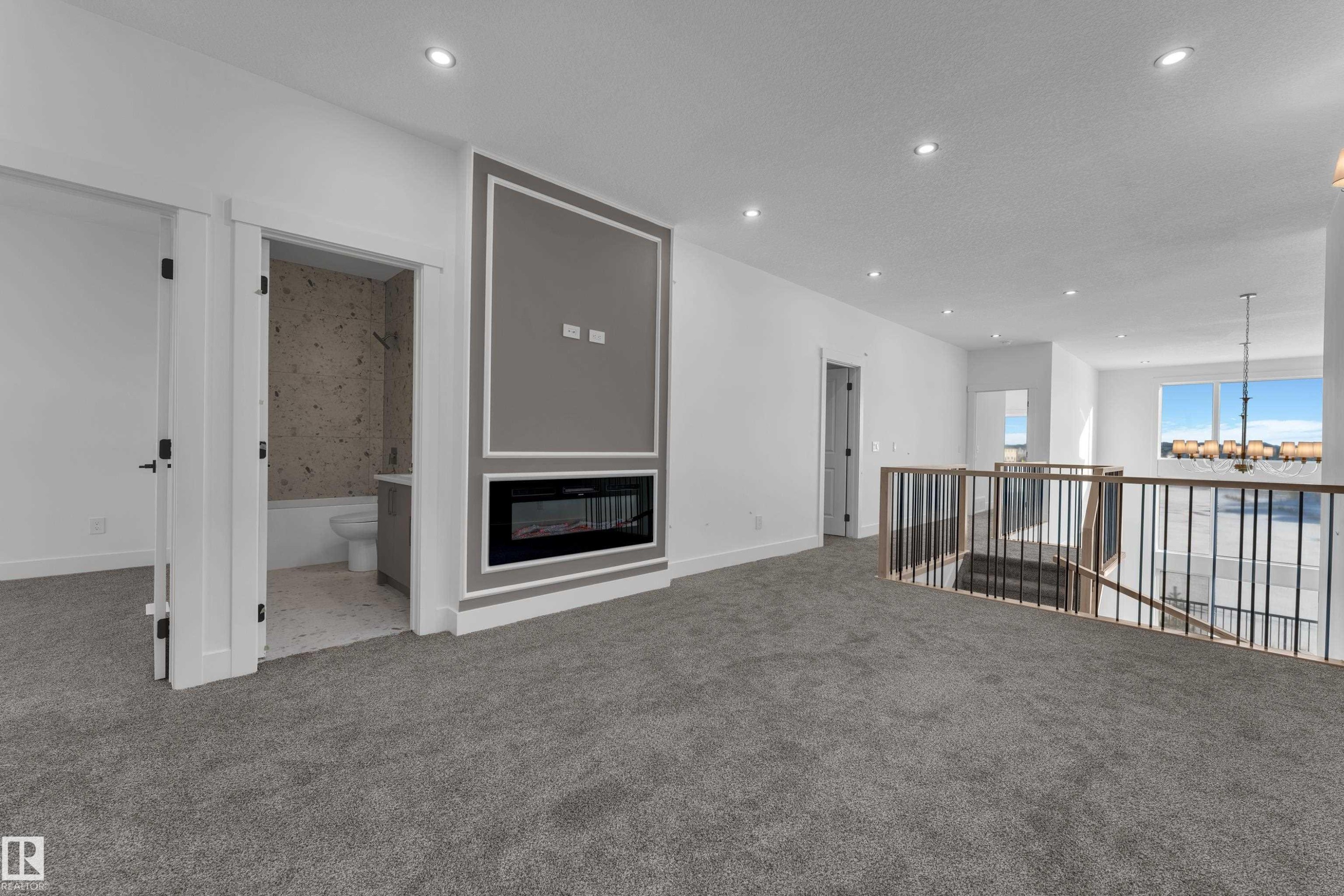 Upper-level bonus room with gray carpet flooring and recessed lighting - 226 Linden Loop, Leduc, AB