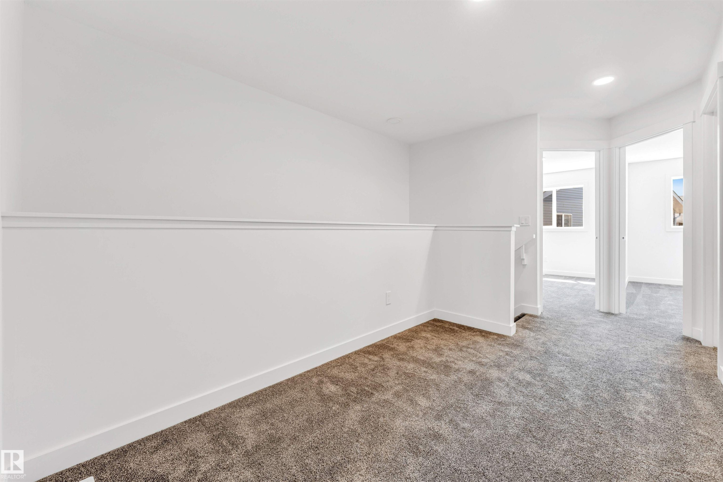 Loft area featuring neutral carpeting, white walls, recessed lighting, and white trim - #48 710 Mattson Dr Sw Sw, Edmonton, AB