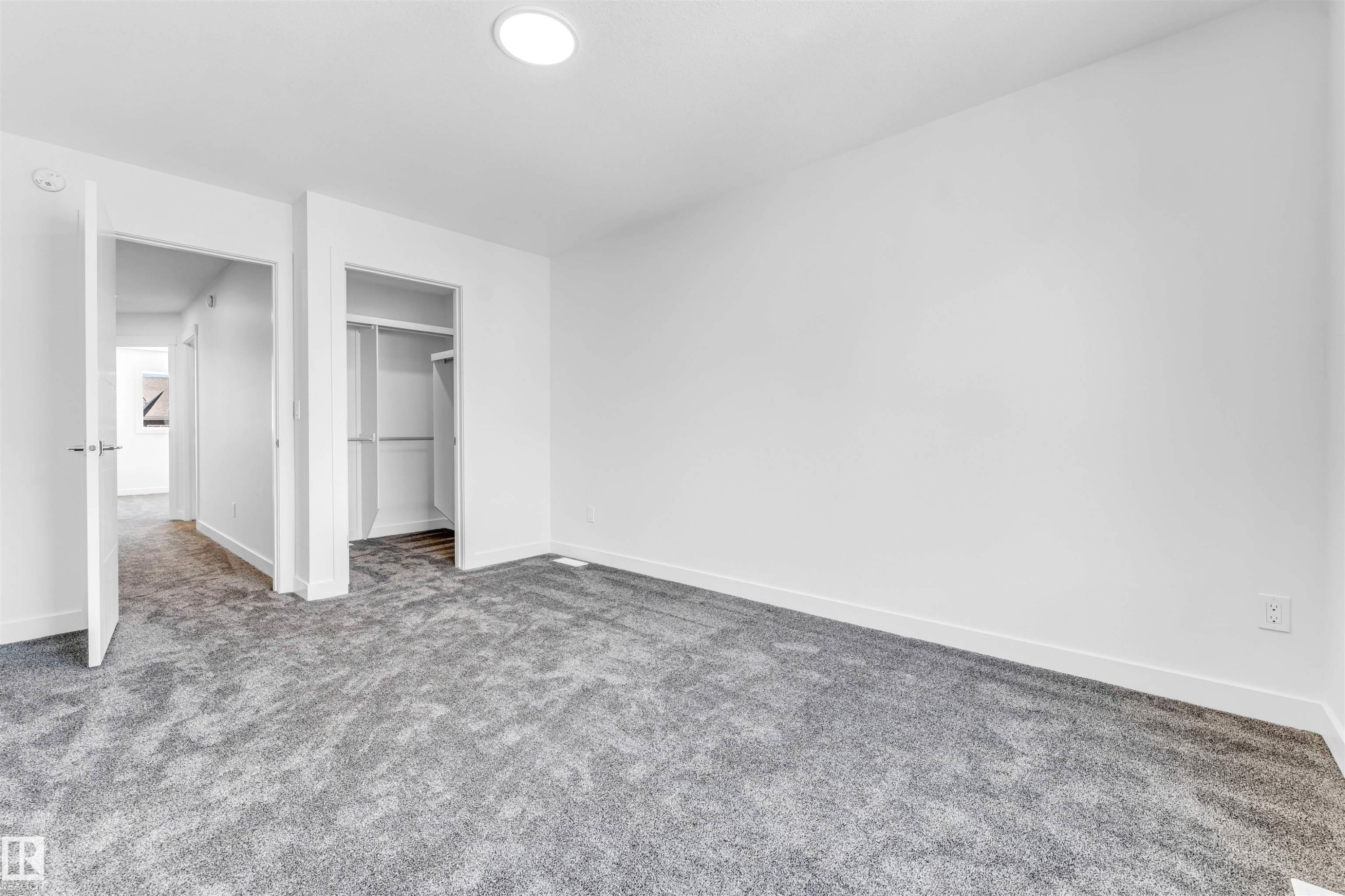 Plush gray carpeting throughout, built-in closet shelving, and a recessed ceiling light - #48 710 Mattson Dr Sw Sw, Edmonton, AB