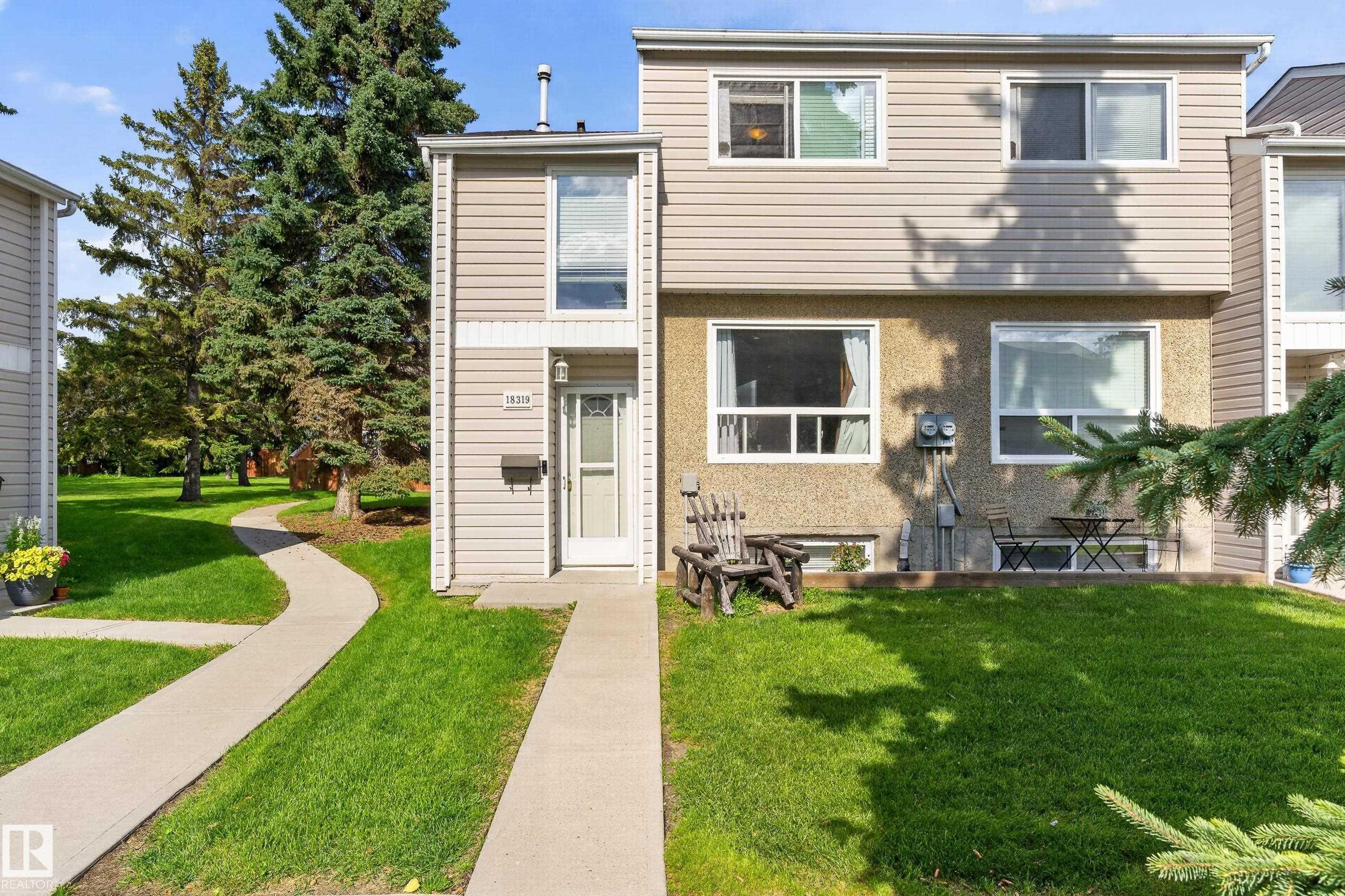 Two-story exterior with light-toned siding and stucco facade - 18319 93 Avenue Nw, Edmonton, AB