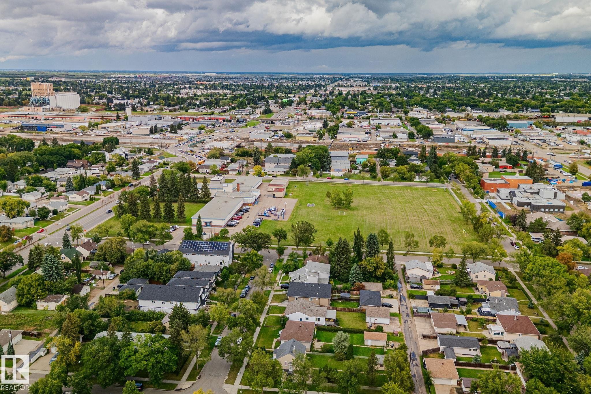 Expansive neighborhood featuring residential homes, commercial properties, and a large open field - 11935 125 Street Nw, Edmonton, AB