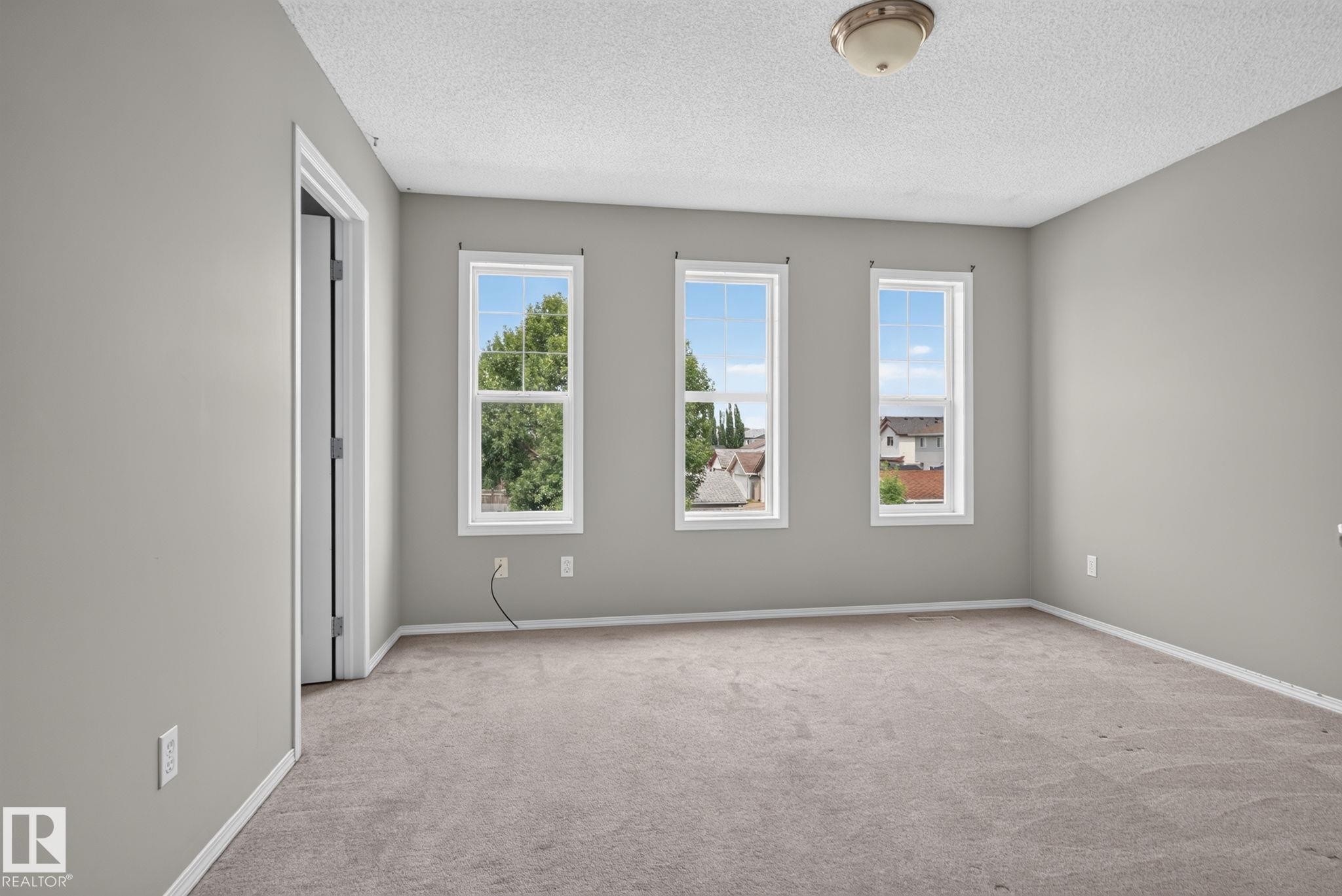 Three double-hung windows provide ample natural light - 8923 173 Avenue Nw, Edmonton, AB