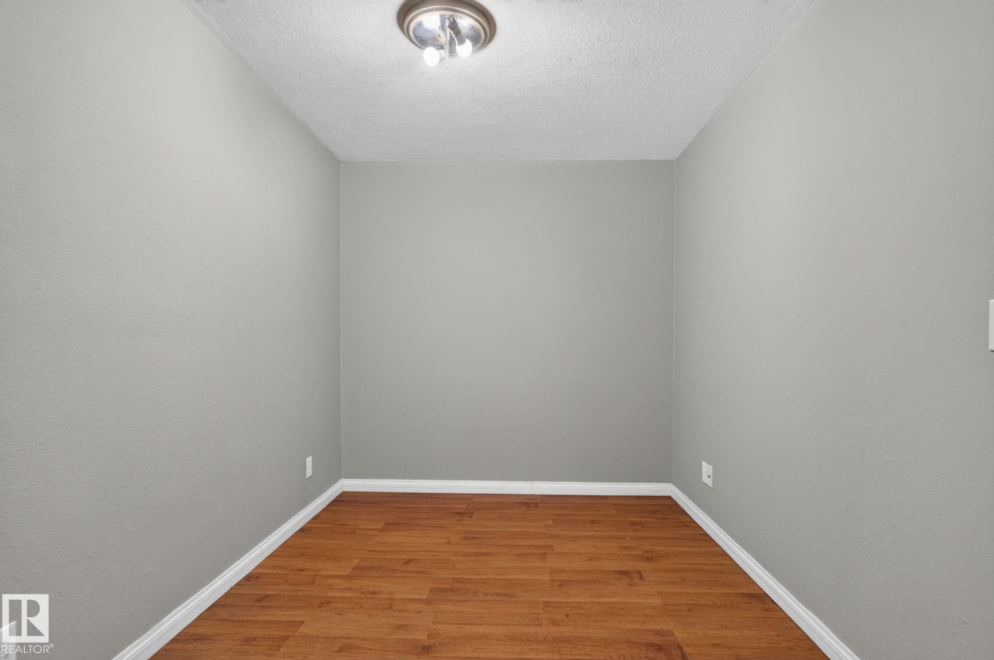 Wood-finish flooring, neutral wall tones, and overhead lighting - 8923 173 Avenue Nw, Edmonton, AB