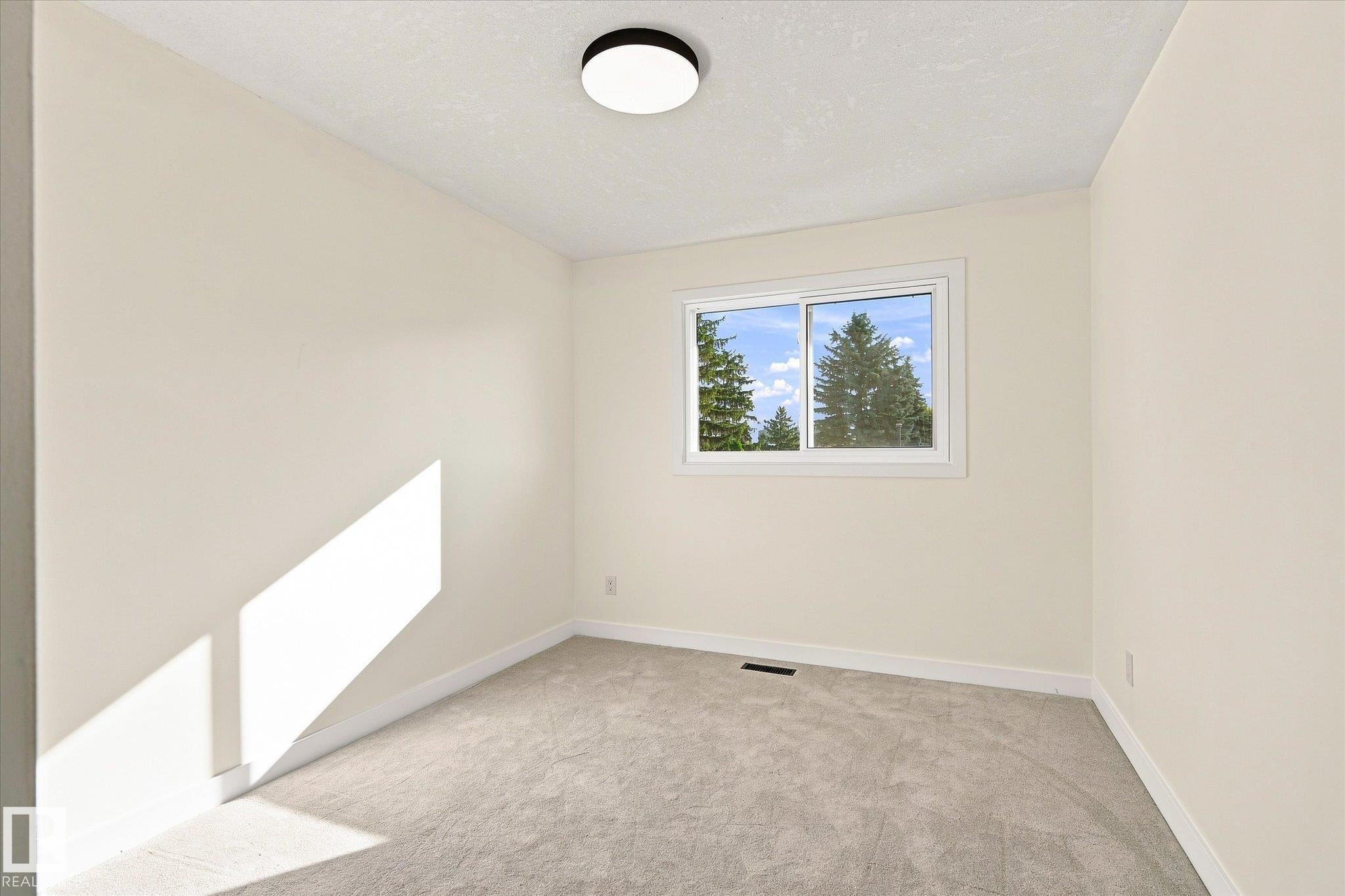 Neutral-toned walls, light gray carpeting, and a white-framed sliding window - 17325 85 Avenue Nw, Edmonton, AB