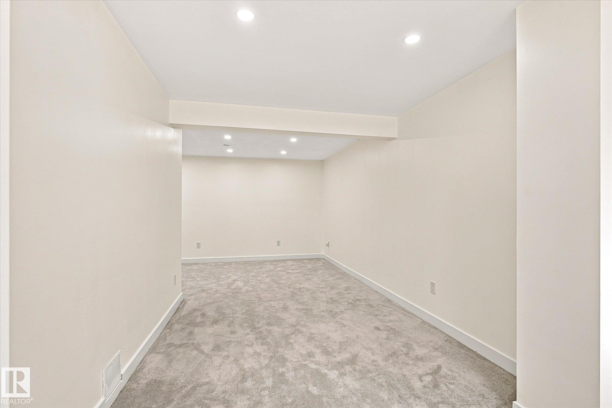 Recessed lighting, light gray carpeting, and neutral wall paint - 17325 85 Avenue Nw, Edmonton, AB