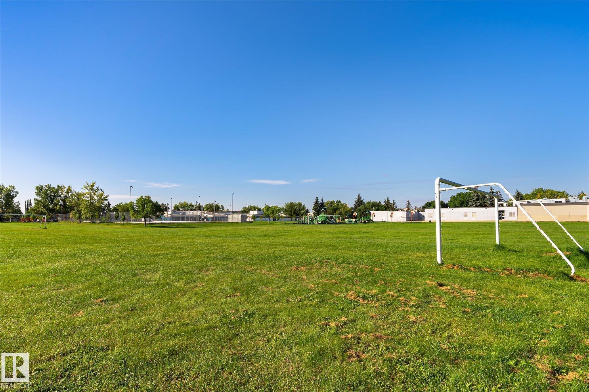 Expansive green space featuring a soccer goal and distant structures - 17325 85 Avenue Nw, Edmonton, AB