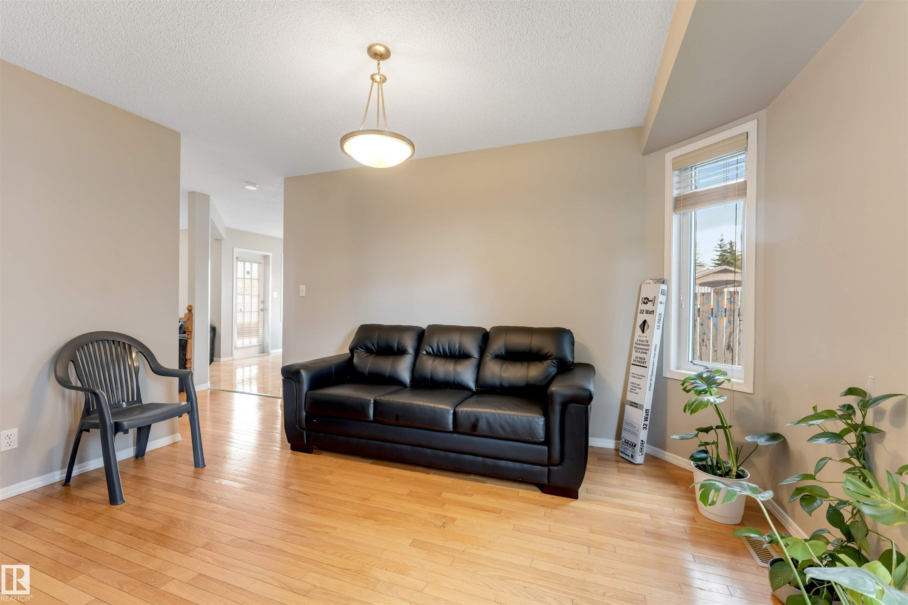 Hardwood-finish flooring throughout, complemented by neutral wall tones - 4465 32A Street Nw, Edmonton, AB - Indoor Photo Showing Living Room