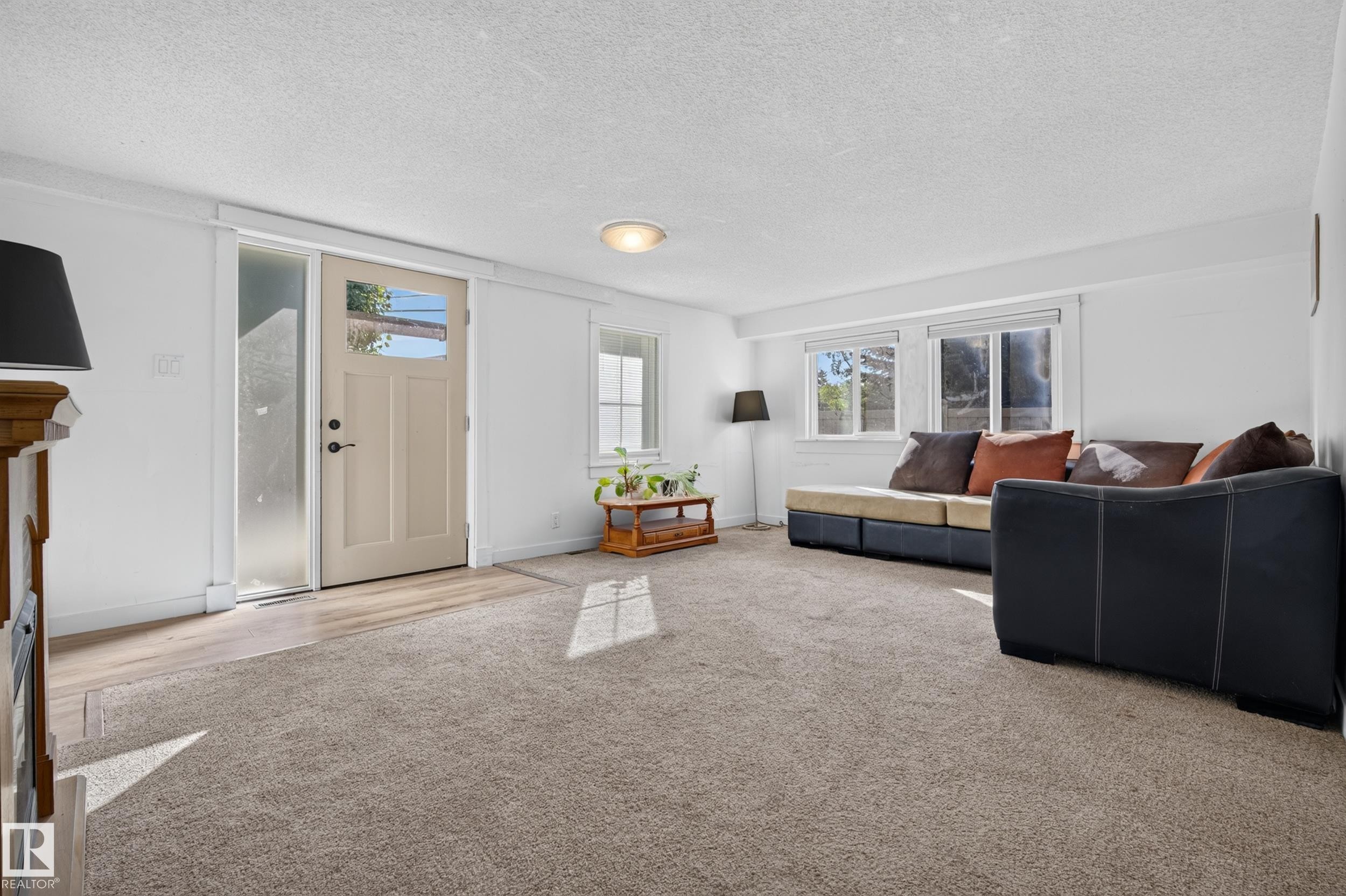 Entry door with frosted glass sidelight, wood-finish flooring, recessed lighting, and multiple windows - 11603 72 Avenue Nw, Edmonton, AB