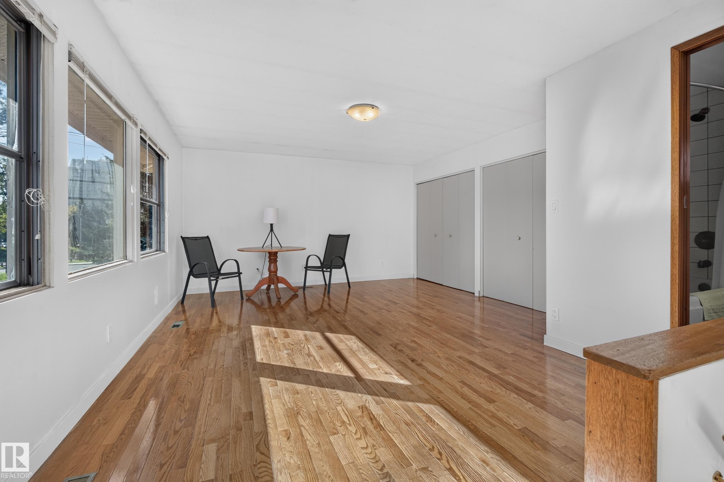 Hardwood flooring, multiple windows, two sets of bi-fold closet doors, and recessed ceiling lighting - 11603 72 Avenue Nw, Edmonton, AB