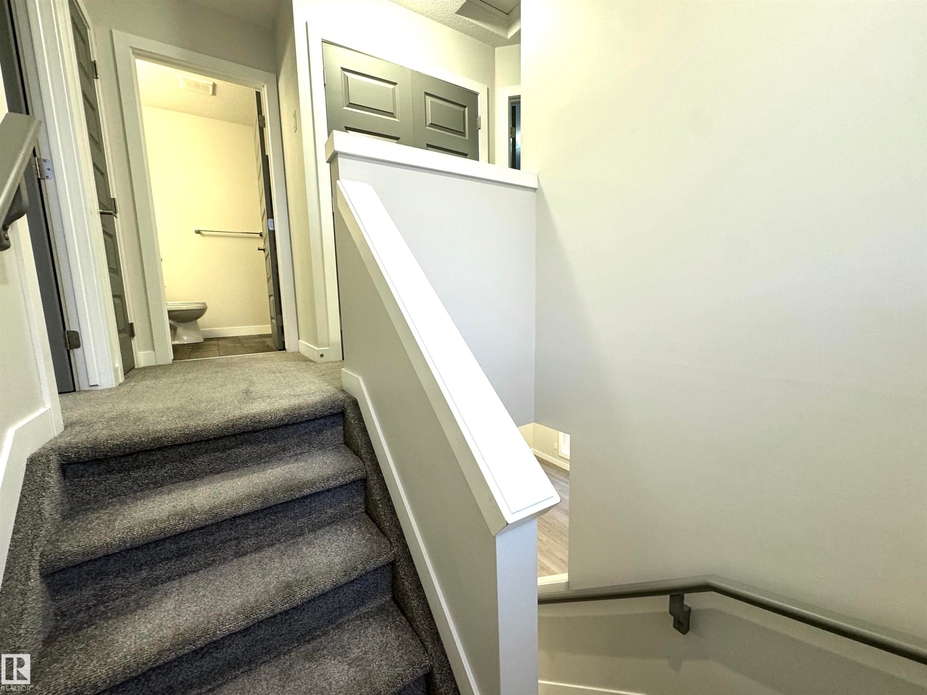 Carpeted staircase with light gray walls and white trim - 12046 89 Street Nw, Edmonton, AB