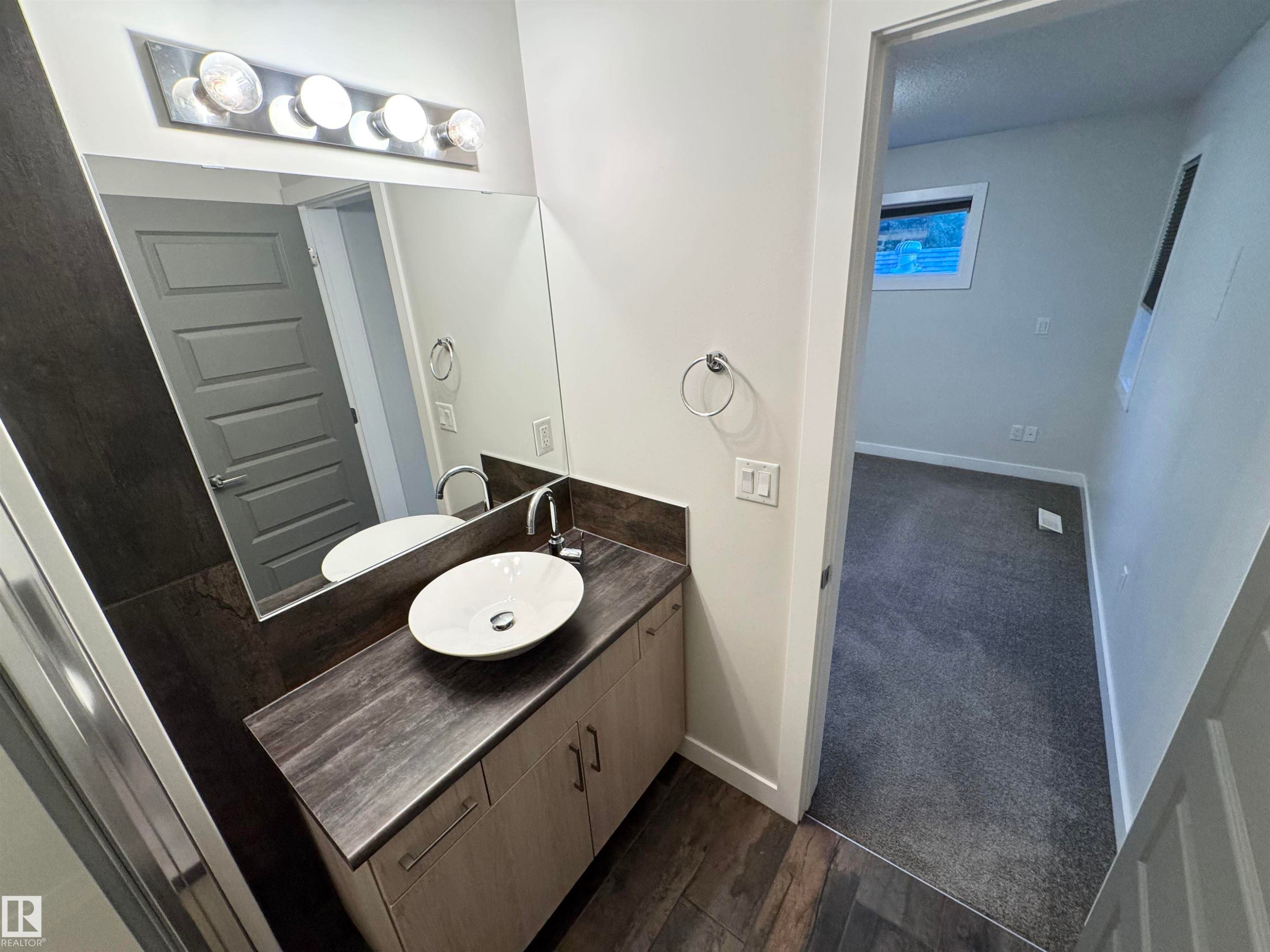 Vanity with a vessel sink, chrome faucet, and integrated storage cabinetry - 12046 89 Street Nw, Edmonton, AB