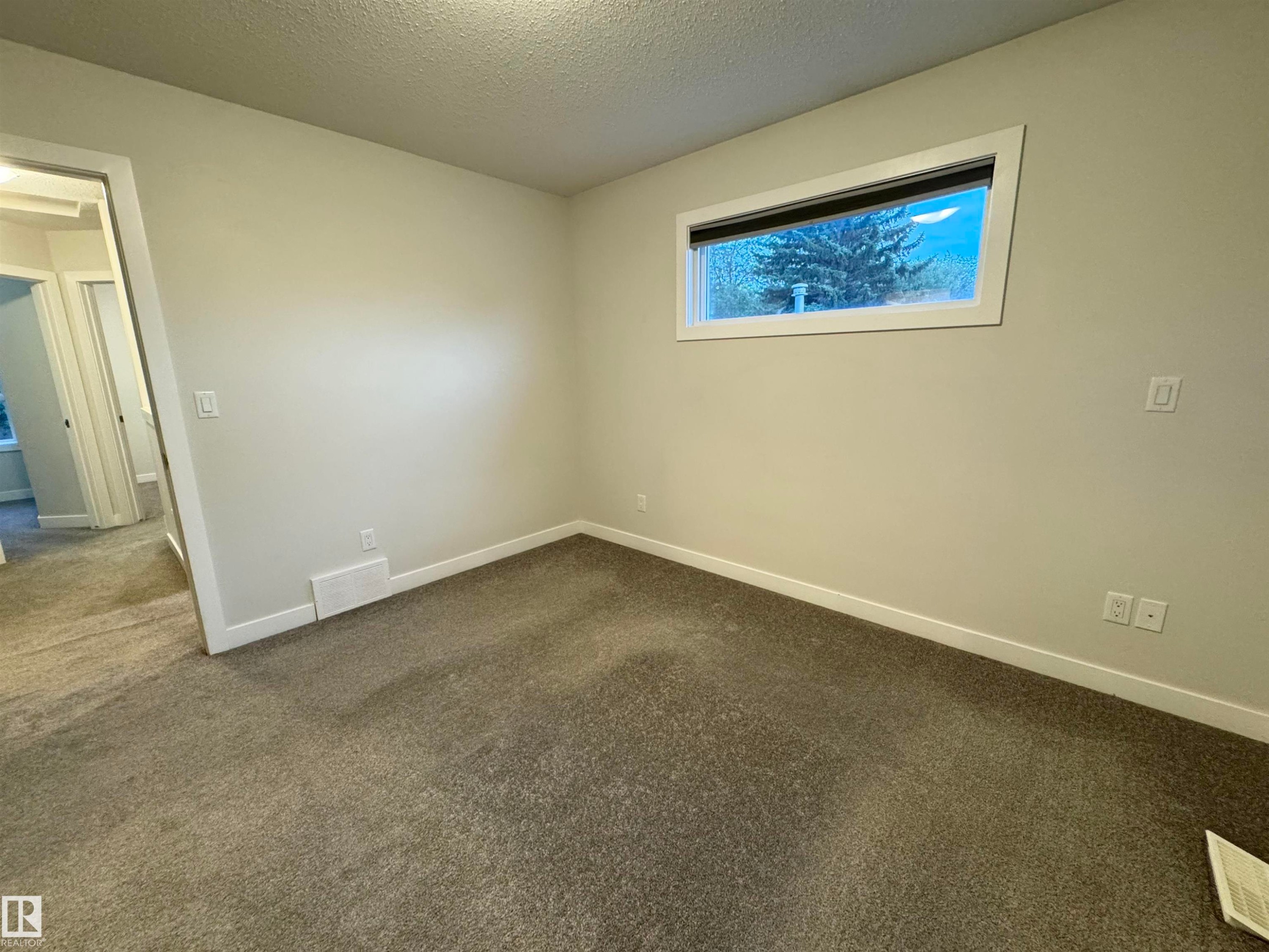 Wall-to-wall carpeting and white trim create a bright interior - 12046 89 Street Nw, Edmonton, AB