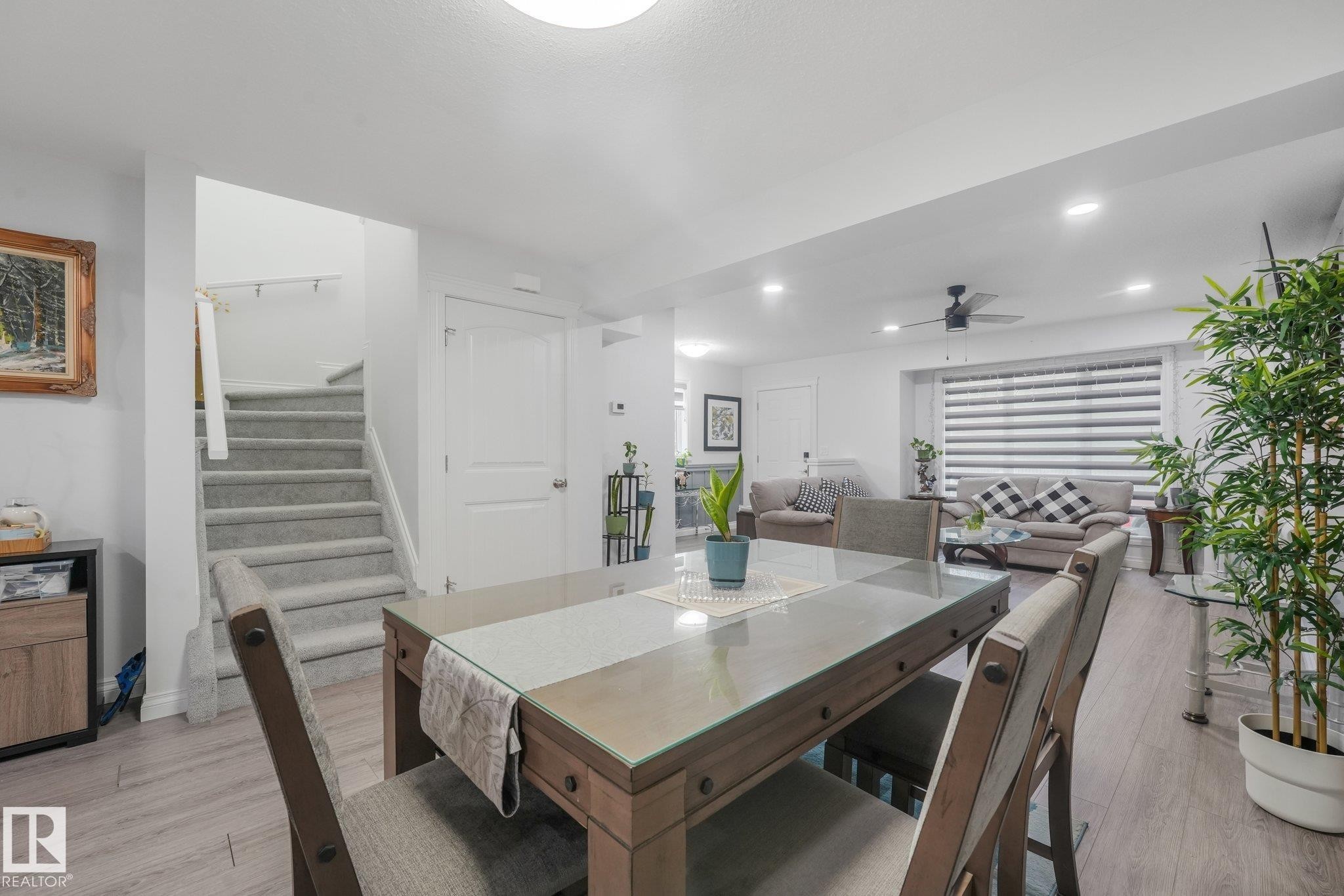 Wood-finish flooring throughout, with a carpeted staircase - 12843 67 Street Nw, Edmonton, AB