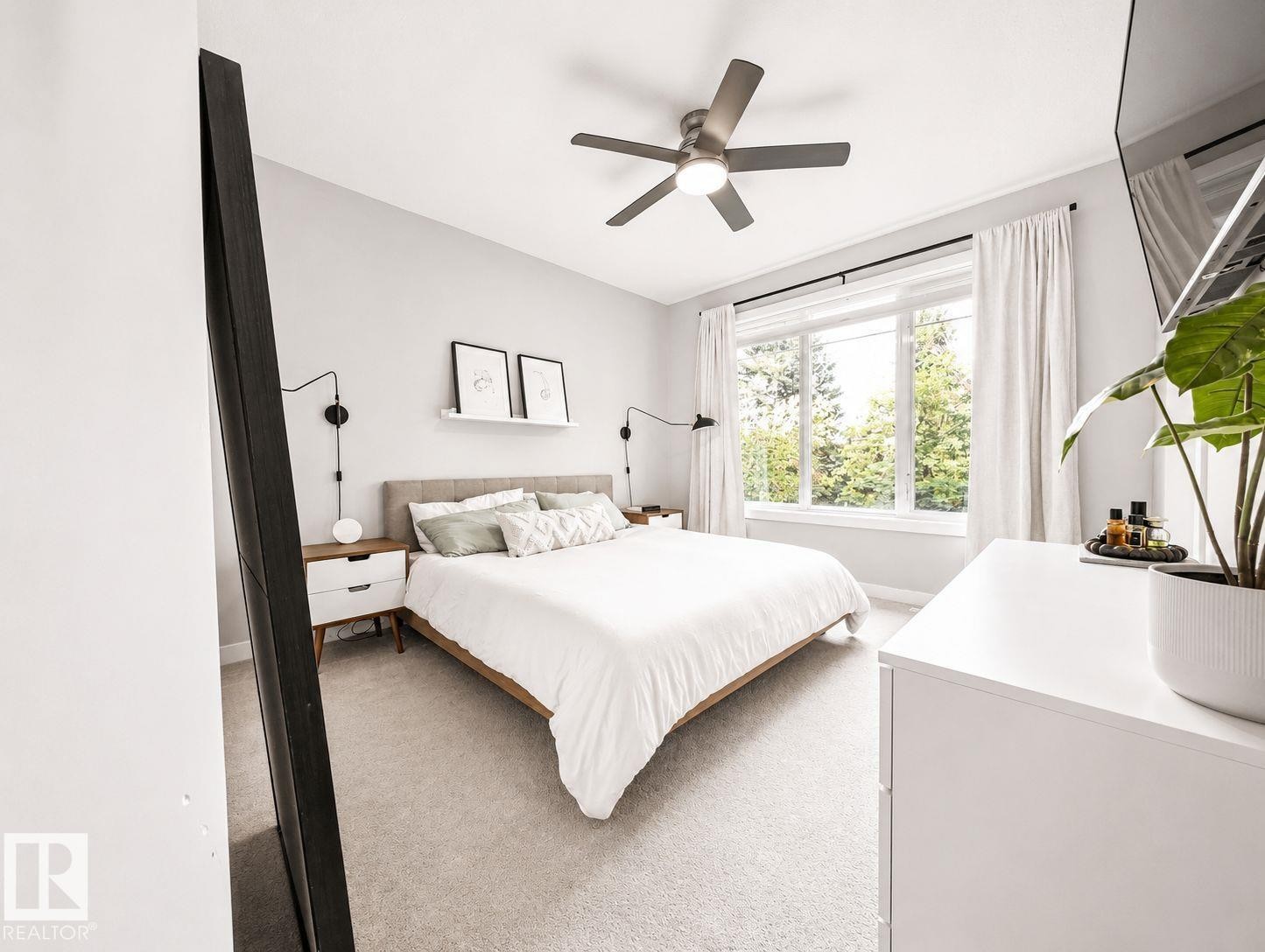 Recessed lighting, ceiling fan, expansive window, neutral wall paint, and light-toned carpet - 10516 76 Street Nw, Edmonton, AB