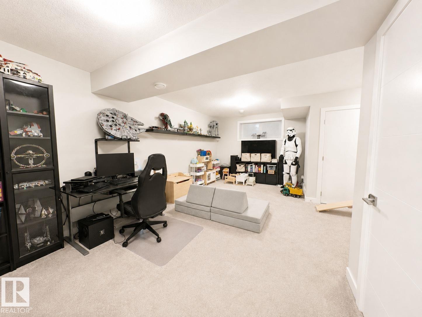 Recessed lighting illuminates a spacious room featuring light-toned carpeting and white walls - 10516 76 Street Nw, Edmonton, AB
