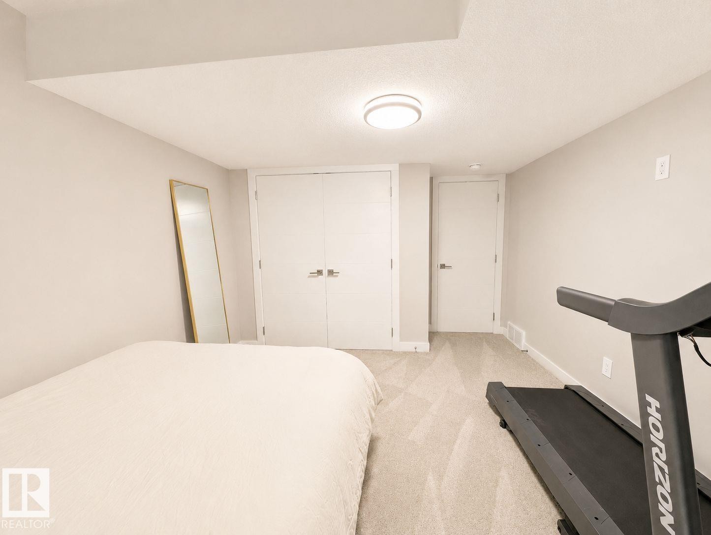 Recessed lighting, light gray carpet, and a built-in closet with double doors - 10516 76 Street Nw, Edmonton, AB