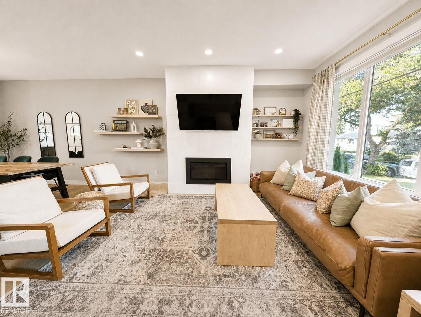 Recessed lighting, wood-finish flooring, built-in fireplace, large picture windows, and light neutral wall tones - 10516 76 Street Nw, Edmonton, AB