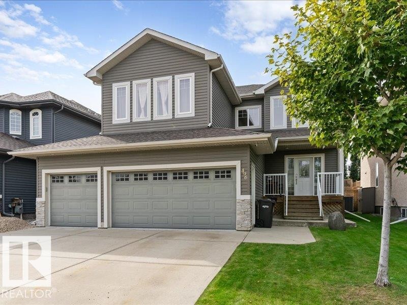 Two-story dwelling with gray siding, a double attached garage, and a concrete driveway - 496 Ravine Court, Devon, AB