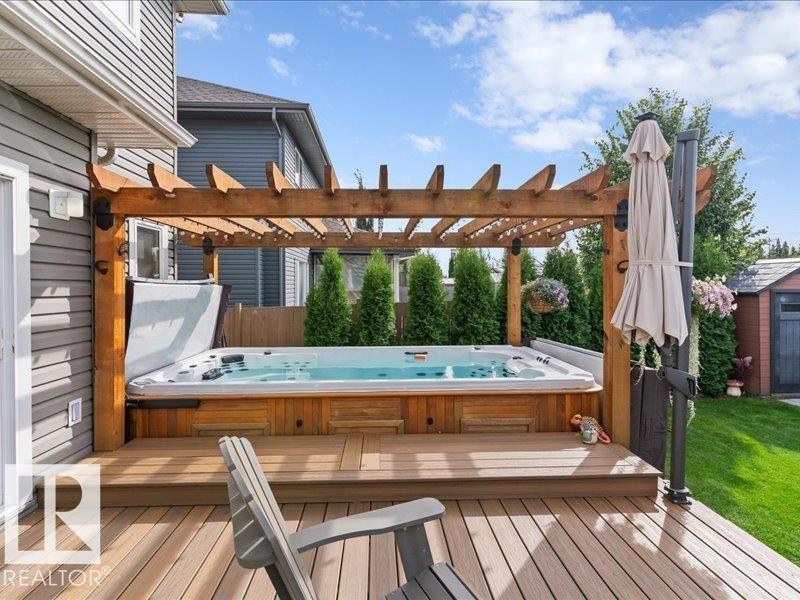 Expansive multi-level wood-finish deck with built-in spa - 496 Ravine Court, Devon, AB